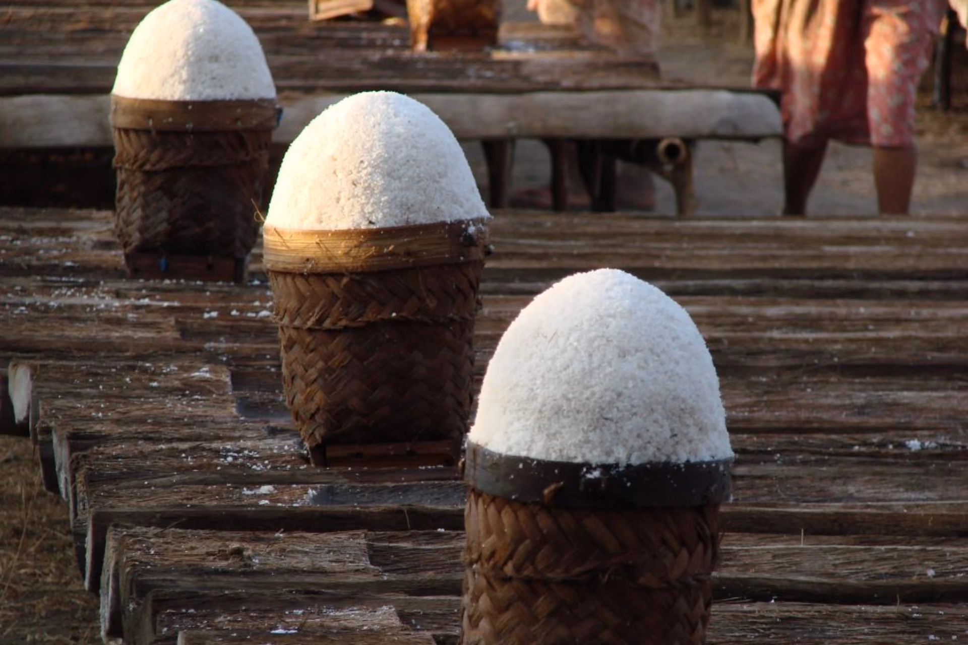 Close-up of traditional salt piles in woven baskets at Amed Salt Centre.