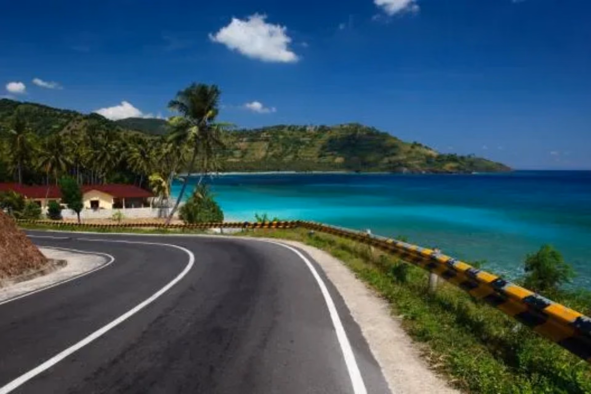 Curved road along blue water at Senggigi Pemenang