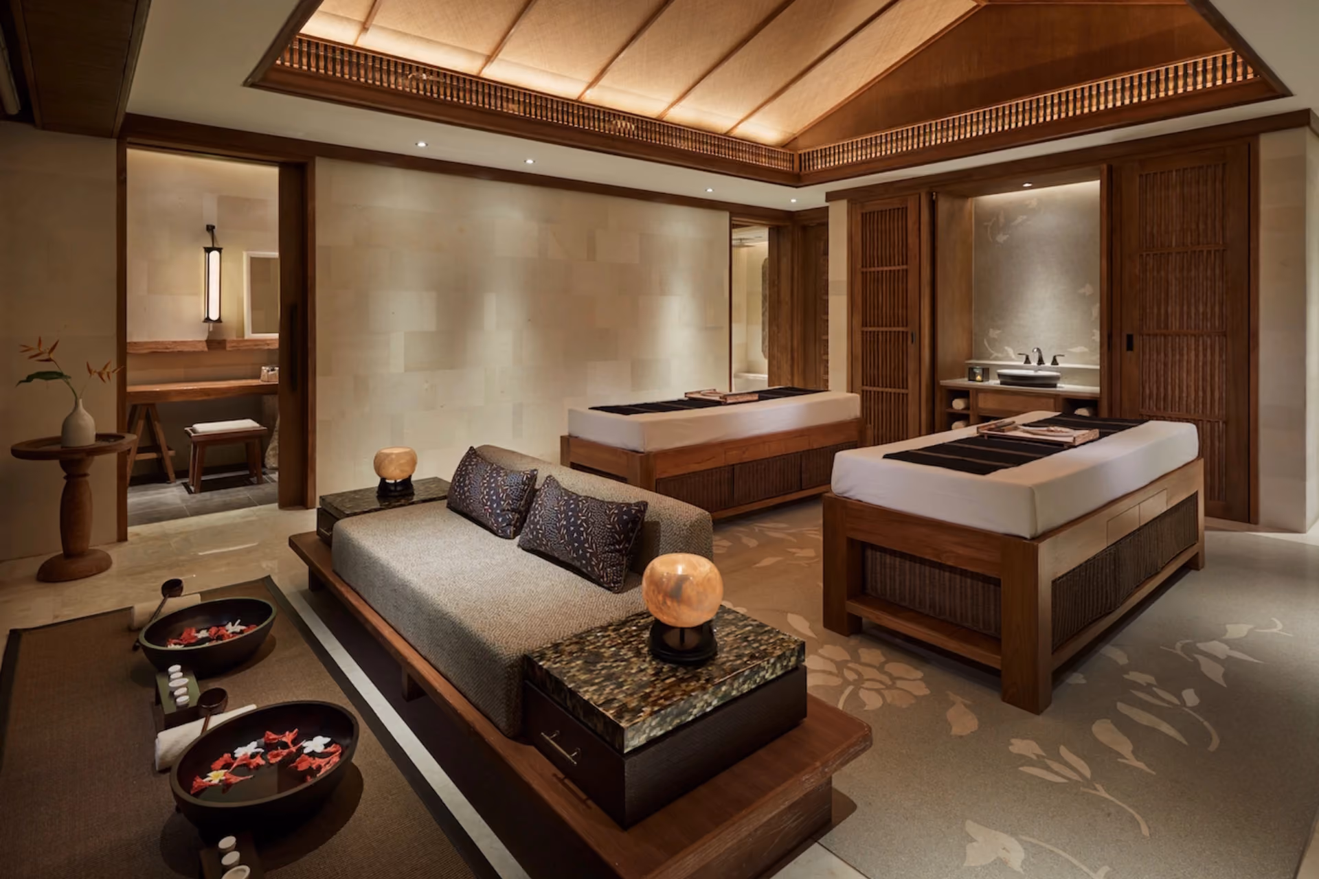 Sanur Spa treatment room with massage beds and wooden decor
