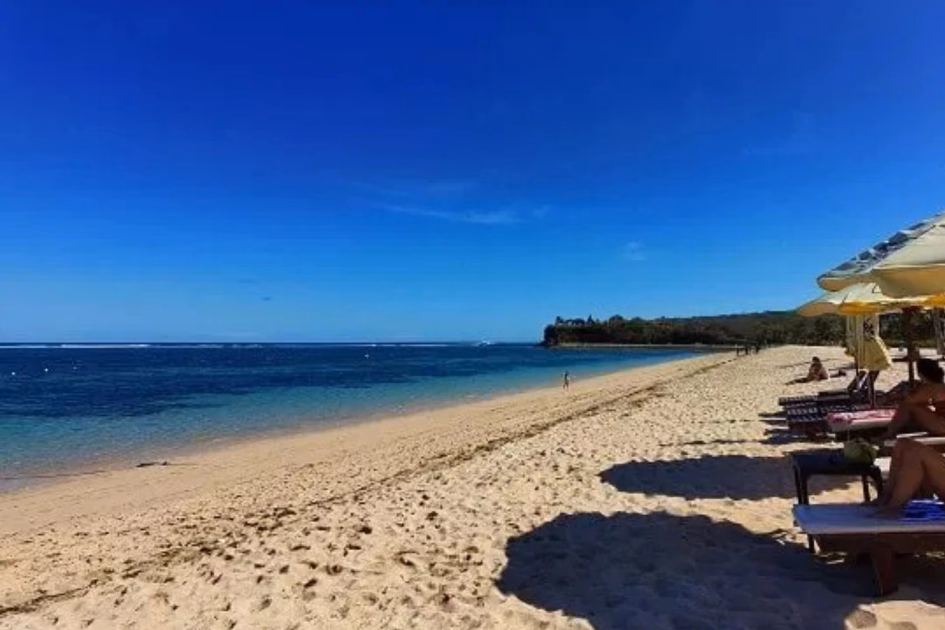 Golden sand and turquoise water at Geger Beach.