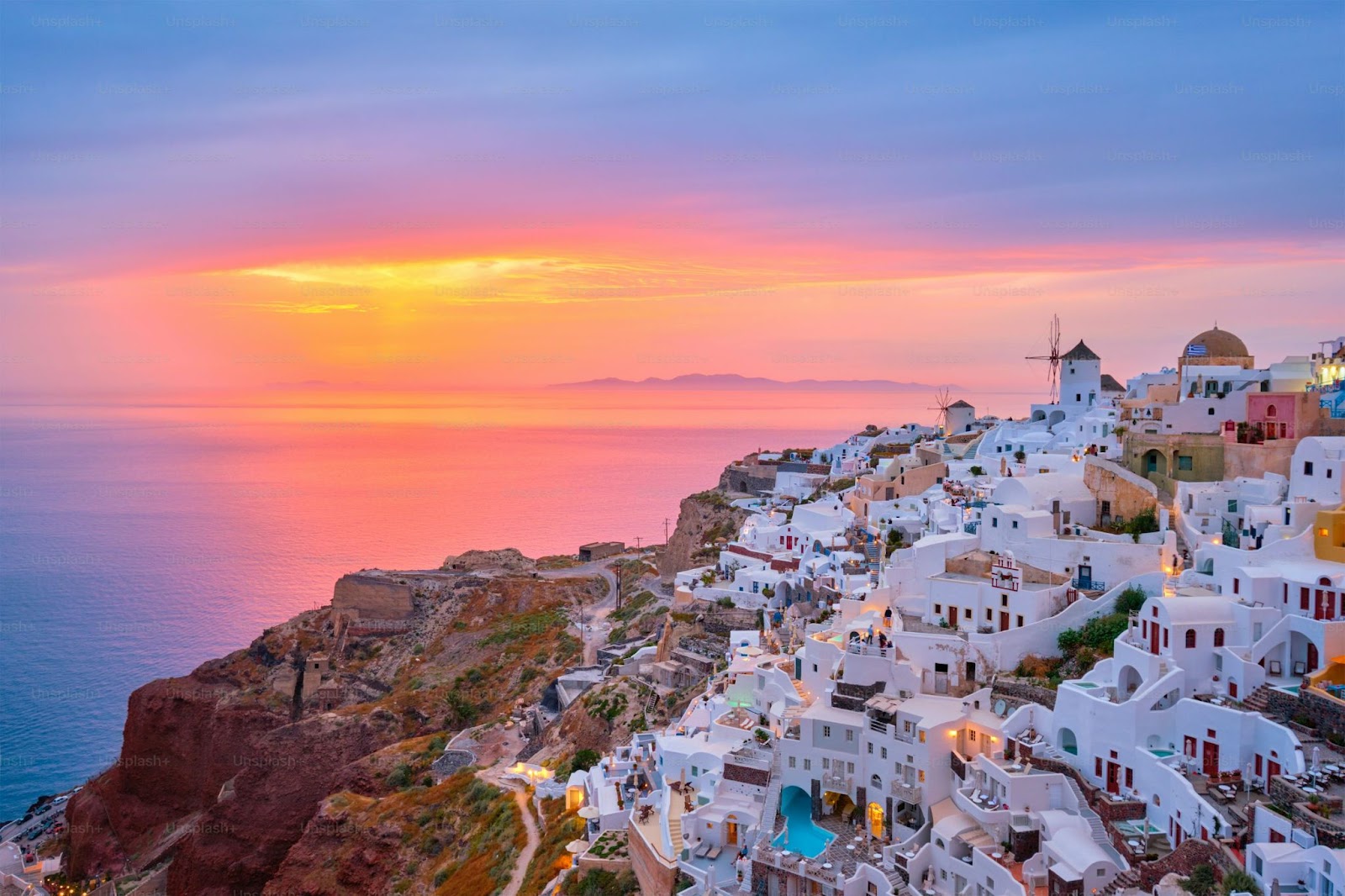 Iconic houses in Santorini overlook the deep blue Aegean Sea.
