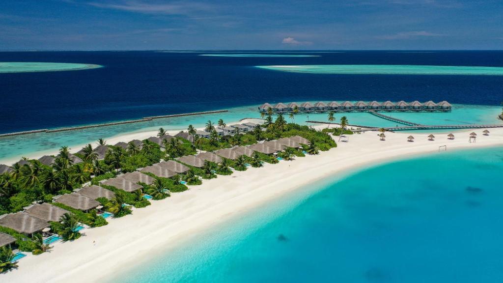 Sun Siyam Iru Veli Maldives featuring beachfront villas with private pools, overwater bungalows, white sandy beaches, and blue lagoon.