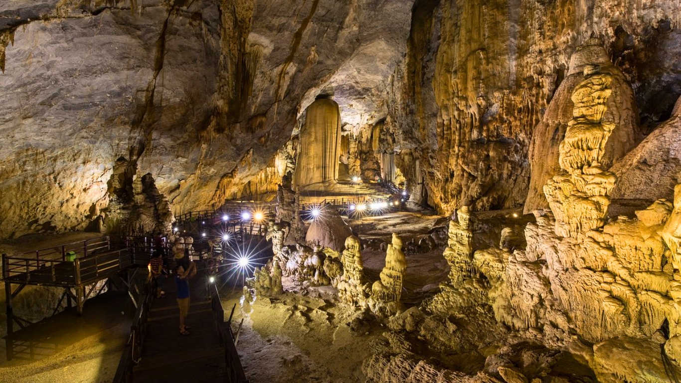 Paradise Cave in Phong Nha, Vietnam, featuring limestone formations, towering stalagmites, and wooden walkways.