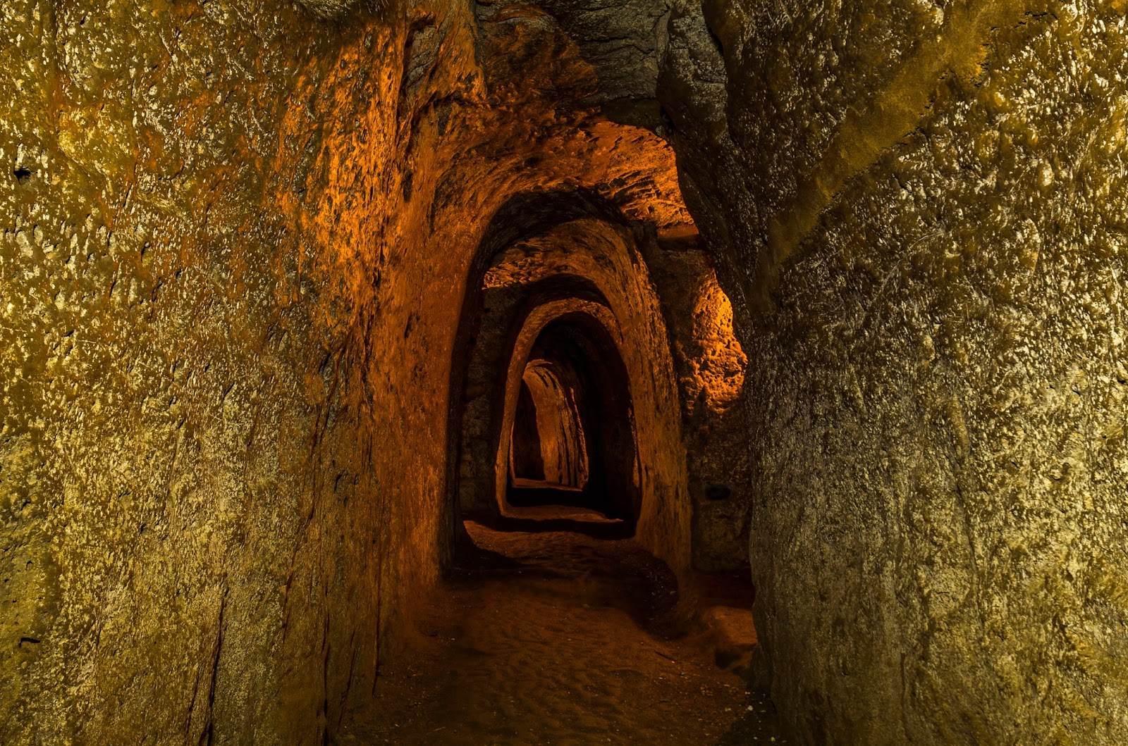 Cu Chi Tunnels in Vietnam, featuring dark, narrow underground corridors.‍