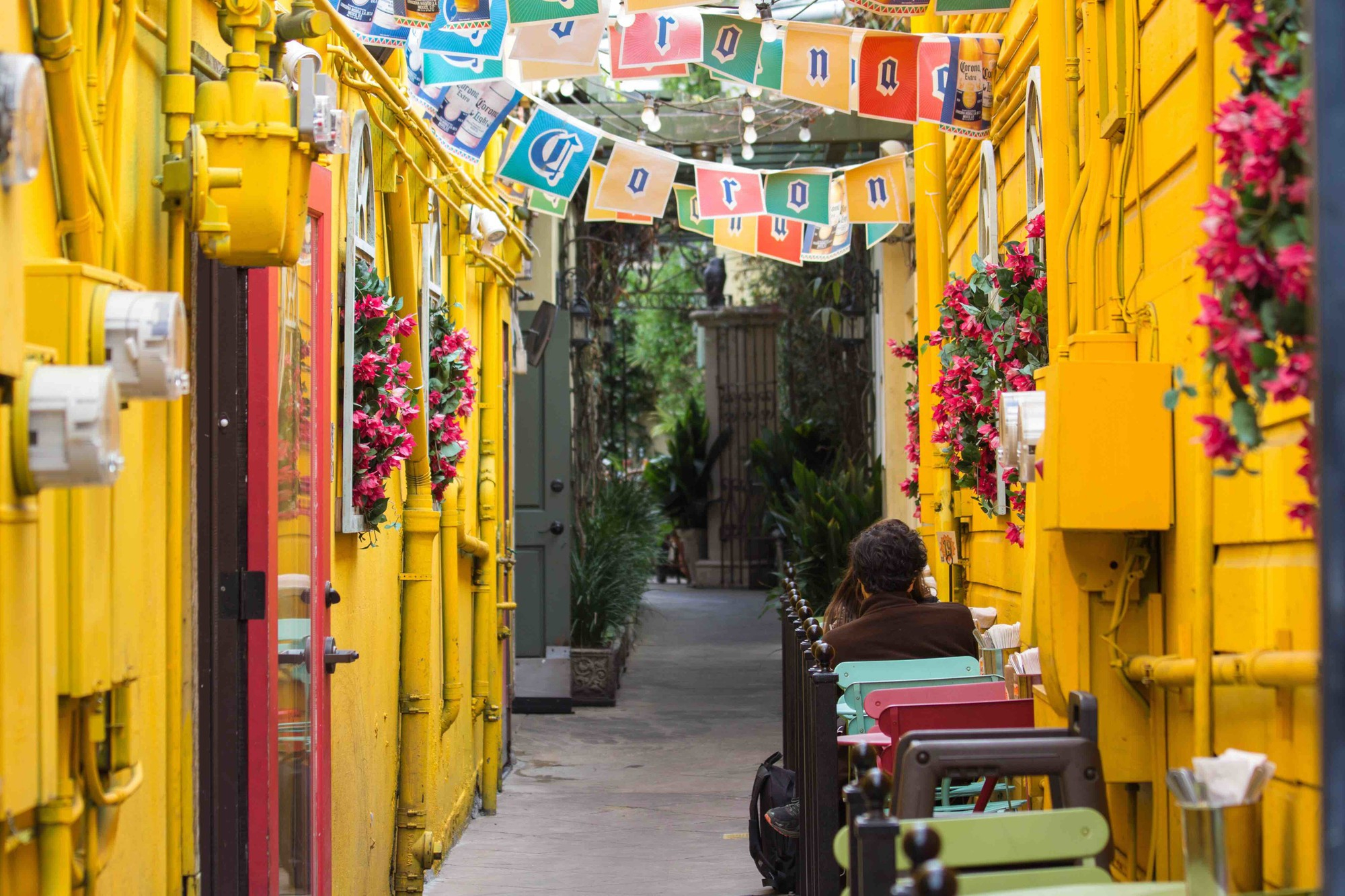 Phuket Old Town showing vibrant yellow colonial-style buildings with arched windows and a clock tower.‍