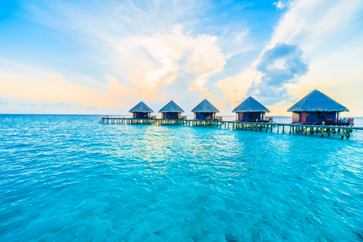 Endless blue waters, overwater villas, and quiet island nights make the Maldives the ultimate romantic summer escape.