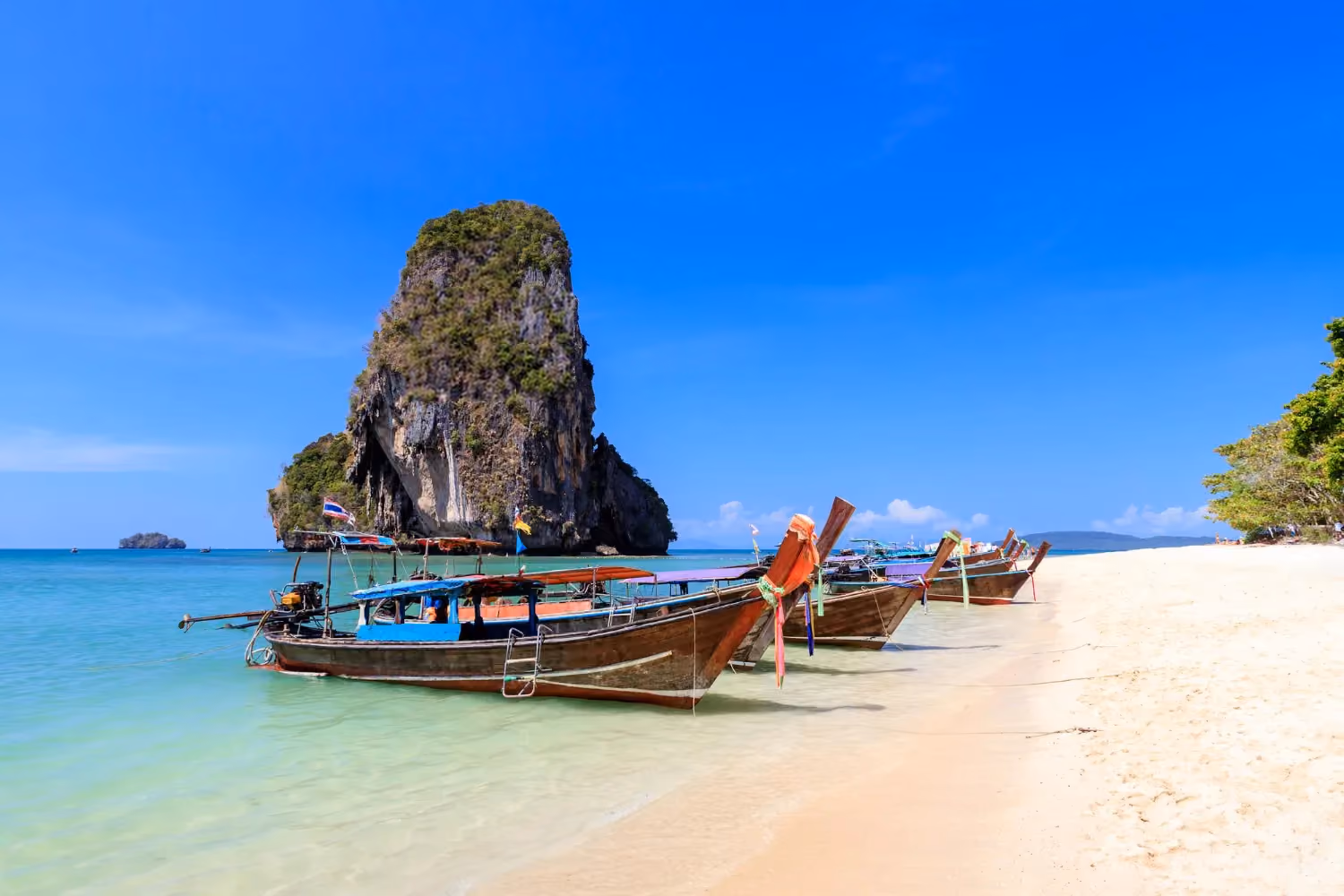 Phuket Island, Thailand, featuring sandy beaches, clear blue waters, and tropical greenery.
