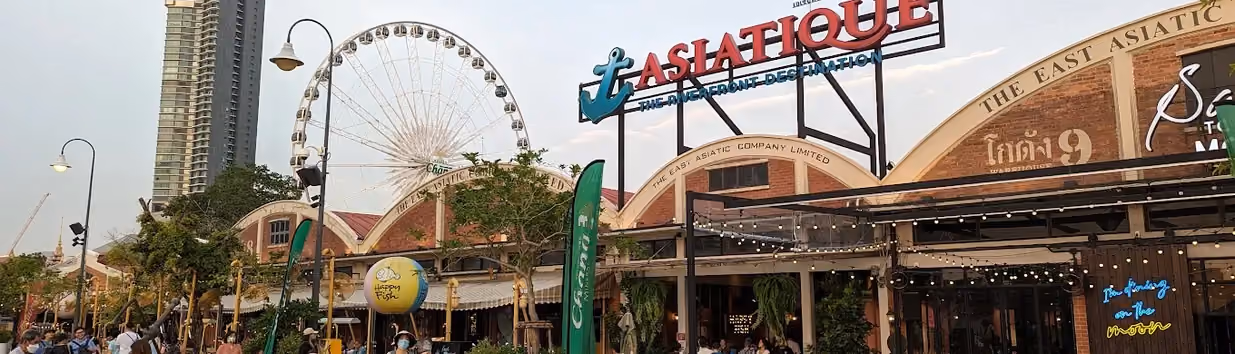 Asiatique The Riverfront in Bangkok, Thailand, a colourful market with shops, restaurants, and ferris wheel.