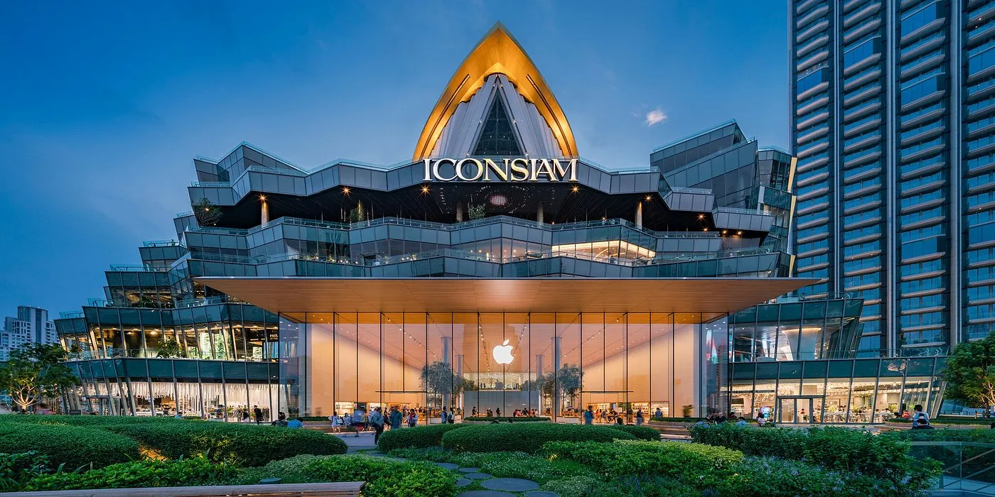 IconSiam shopping mall in Bangkok, Thailand, lit up at night with a modern riverside design