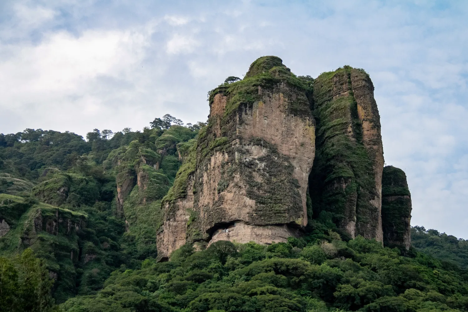 The ancient Sigiriya Rock Fortress rises surrounded by green forests in Sri Lanka
