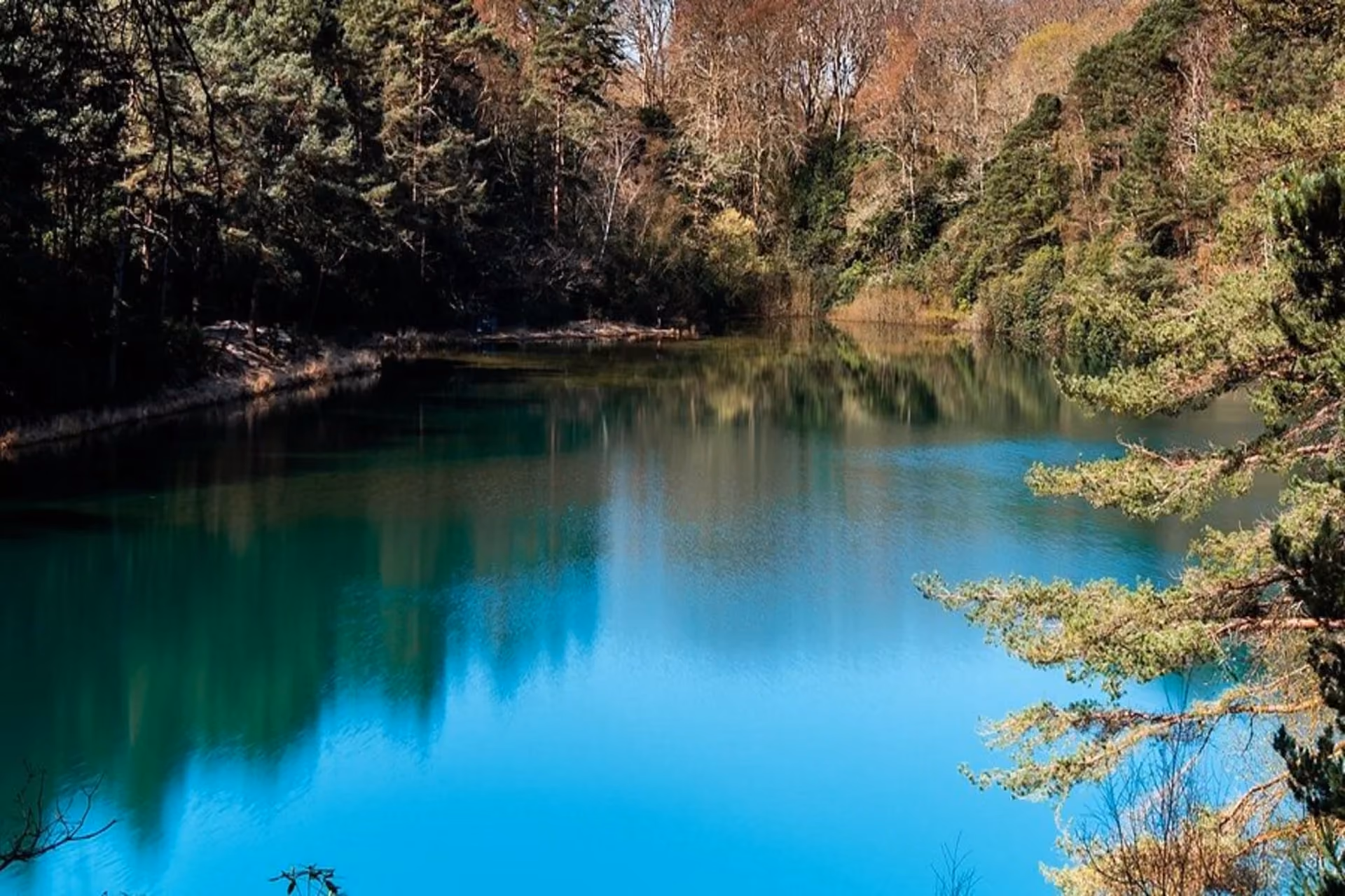 Walk through the forest to the enchanting Blue Pool—famous for its deep sapphire glow