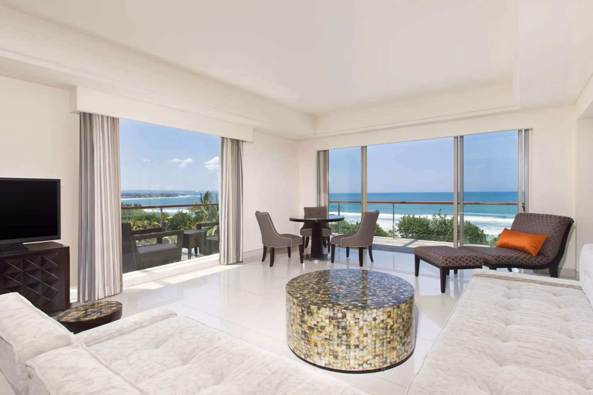 Oceanfront elegance and sunset balcony views at Sheraton Kuta.