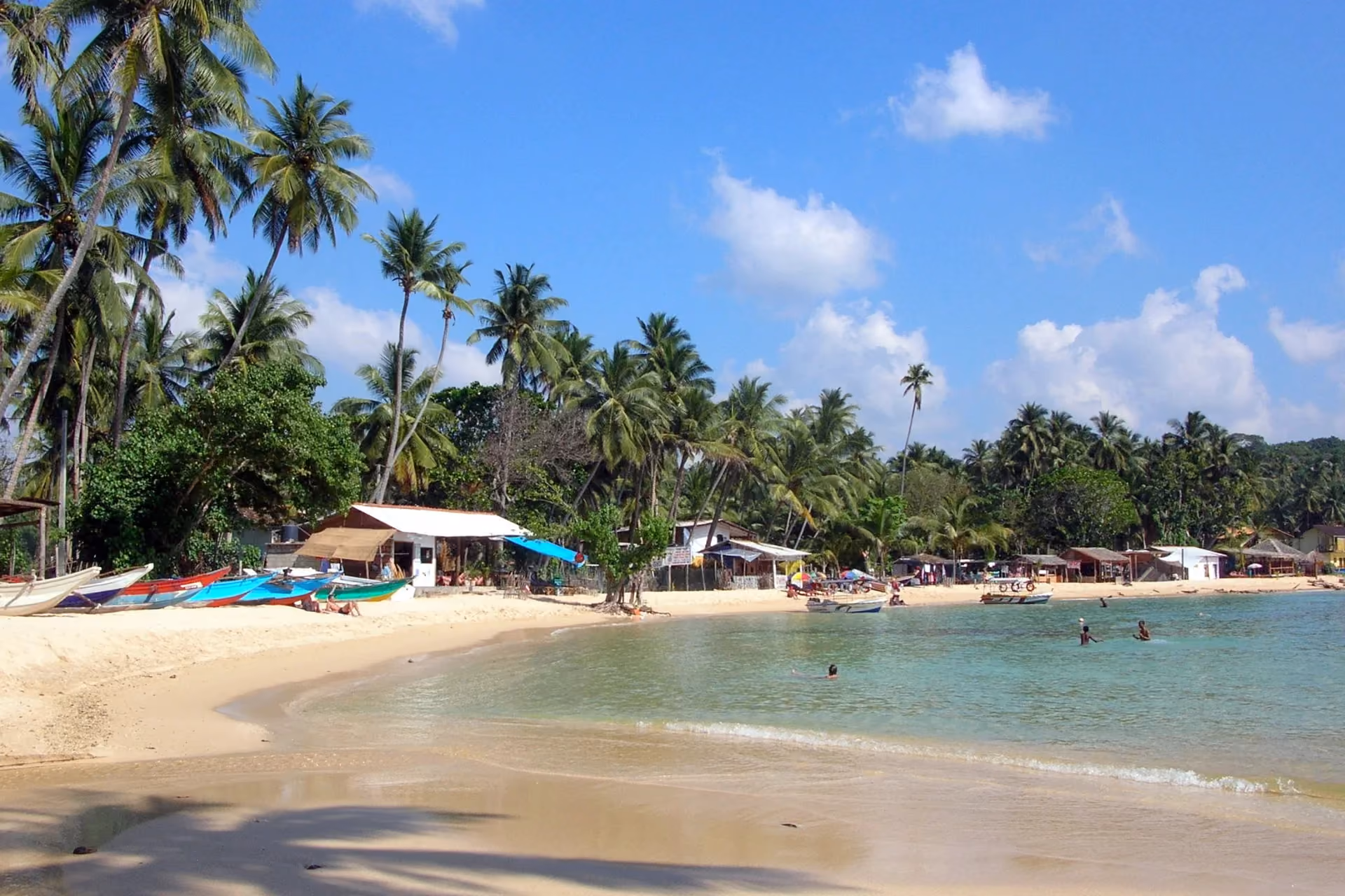 Dive into Unawatuna's crescent bay—one of South Sri Lanka's beaches where coral reefs and calm waters