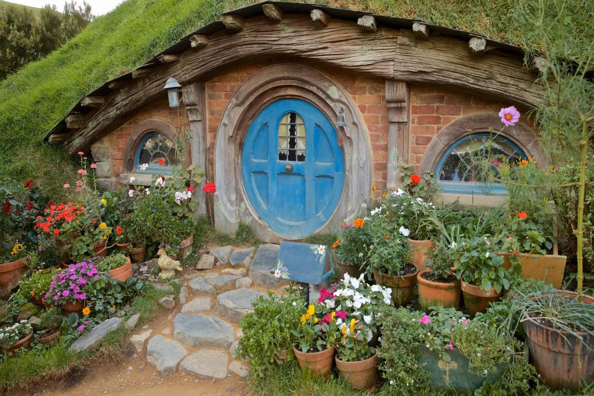Best places to visit in New Zealand - Hobbiton Movie Set with hobbit holes and Shire scenery