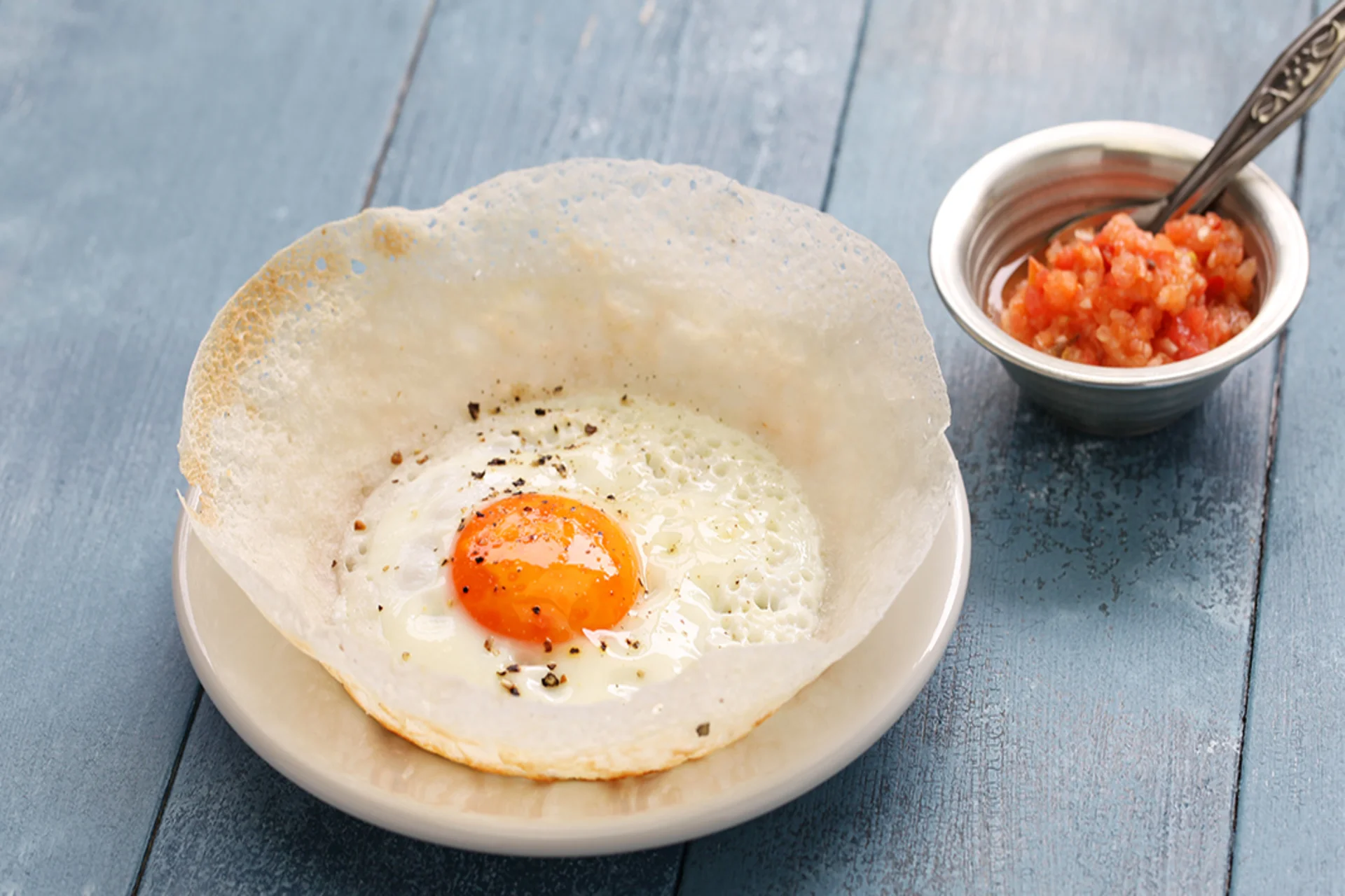 amous Sri Lankan food egg hoppers with crispy edges and a soft egg center