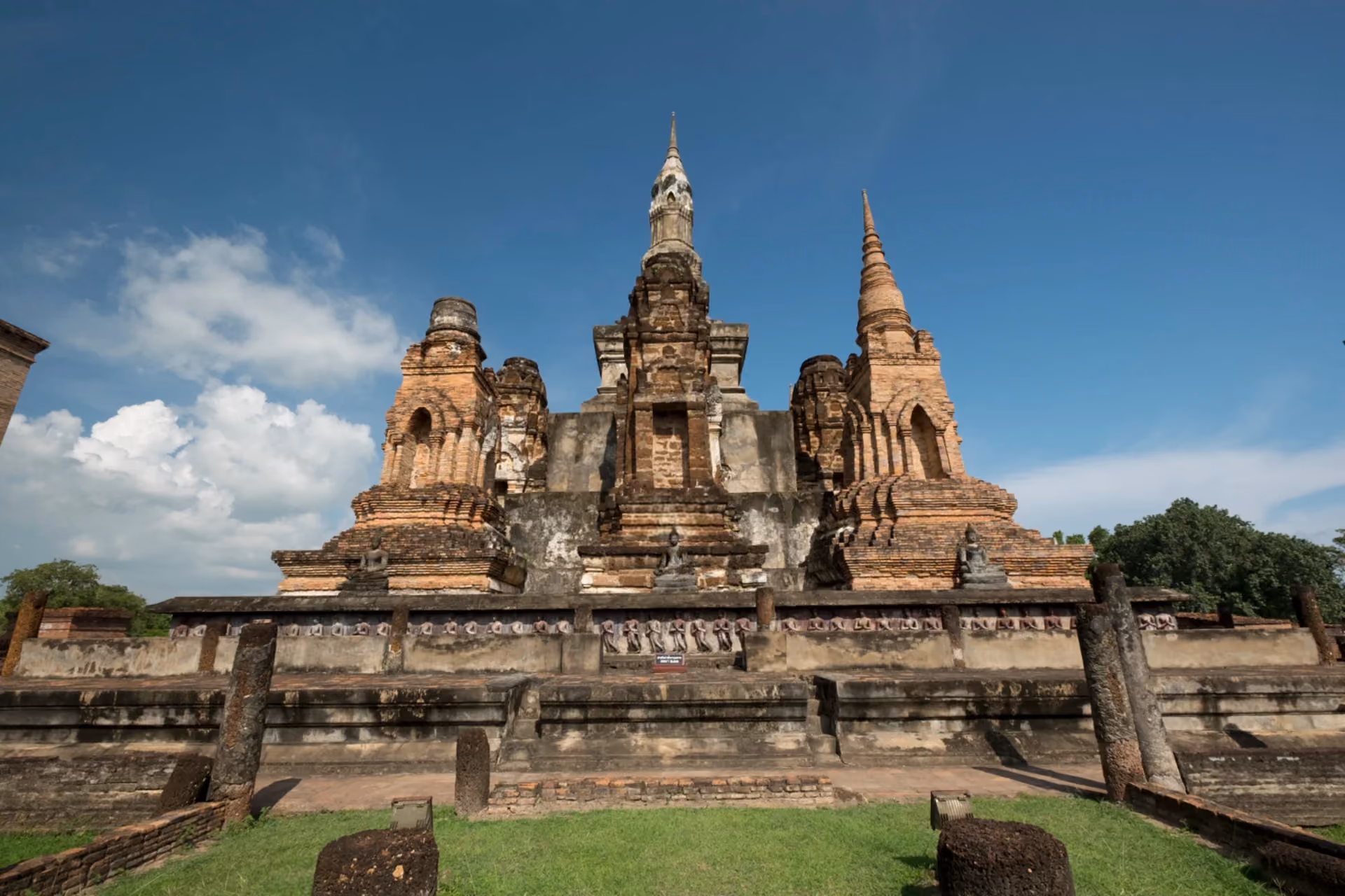 Ancient ruins of Wat Mahathat temple with brick chedis and Buddha statues at Sukhothai Historical Park Thailand, UNESCO World Heritage cultural heritage site