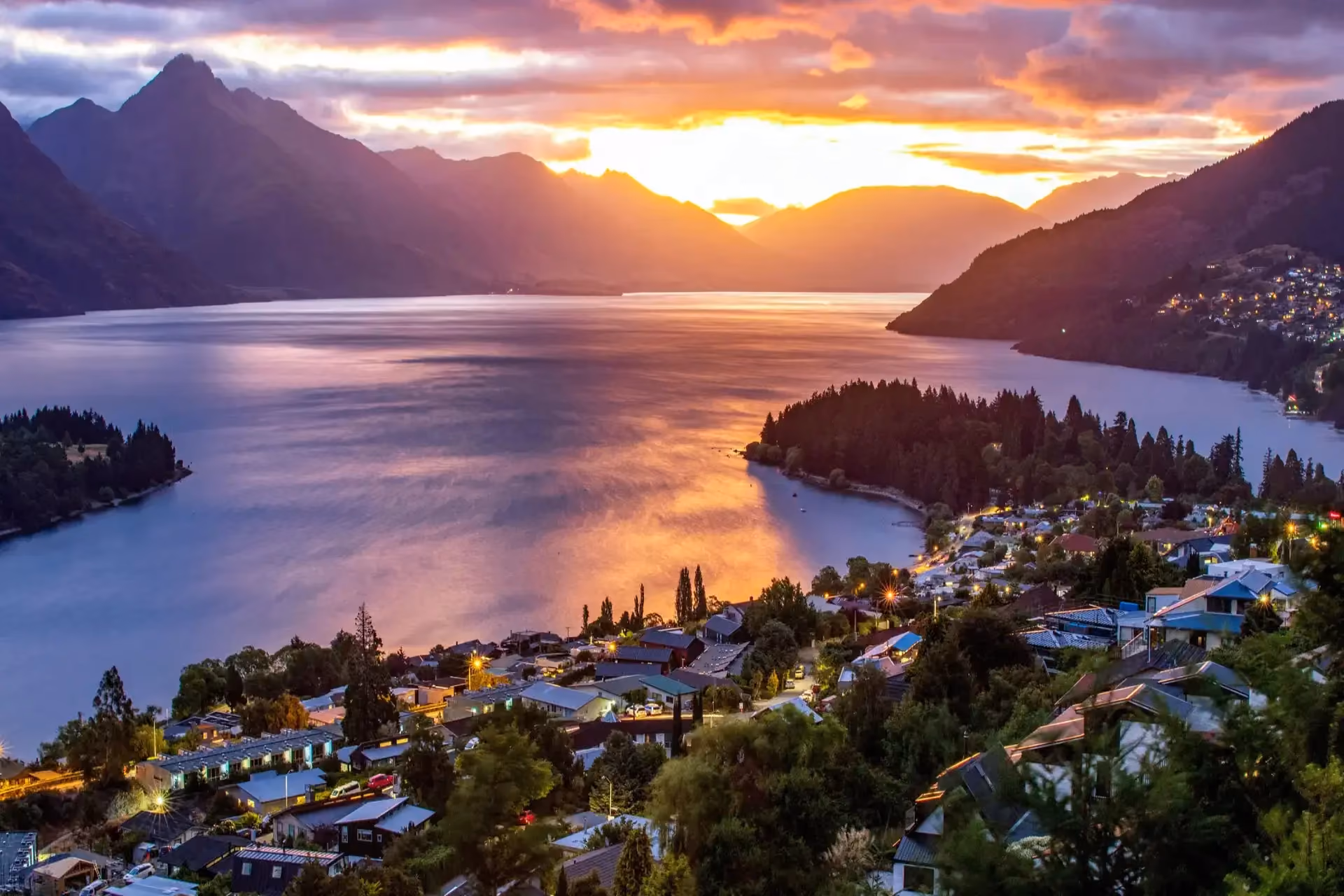 Golden hour on alpine waters — a Lake Wakatipu sunset cruise is the most breathtaking part of your New Zealand cost of travel.