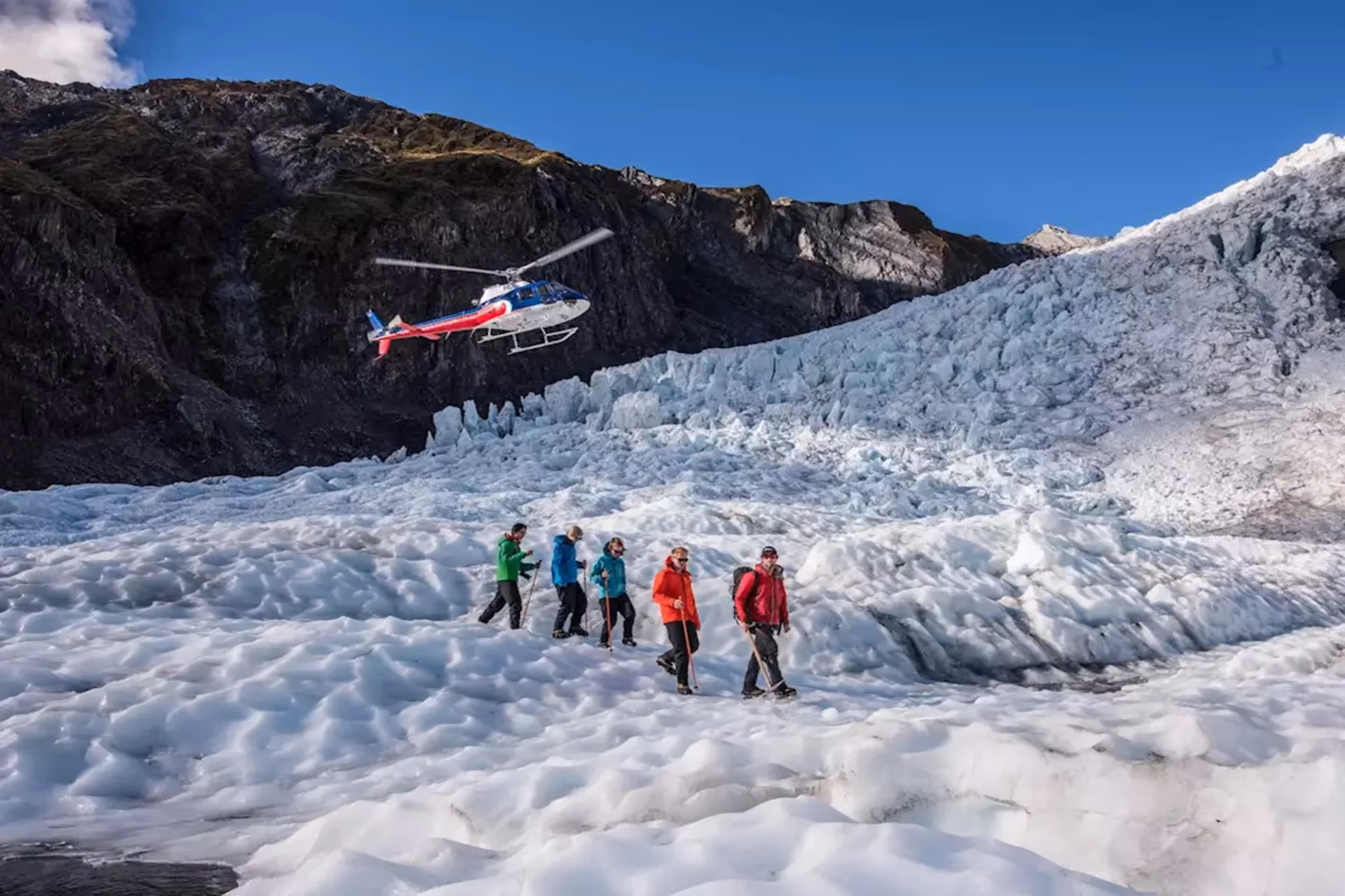 Walk on ice, fly over giants — the glacier heli-hike is the most surreal experience in your New Zealand cost of travel.