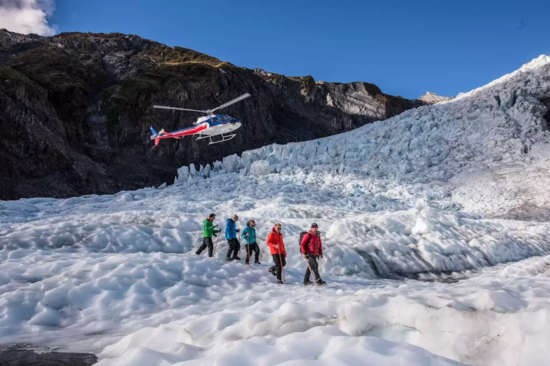 Walk on ice, fly over giants — the glacier heli-hike is the most surreal experience in your New Zealand cost of travel.