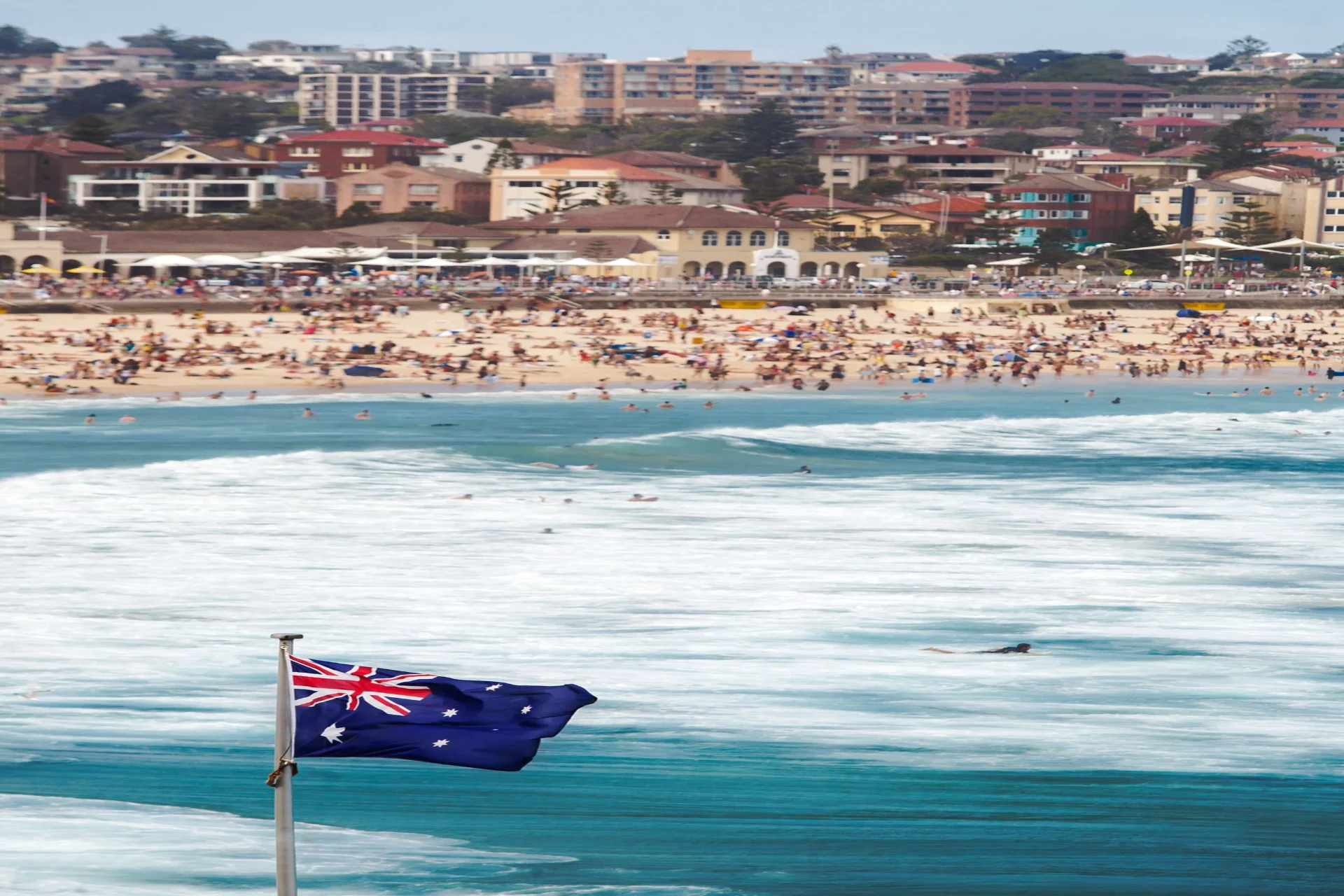 Australian flag at crowded Bondi Beach Sydney luxury countries to visit in September