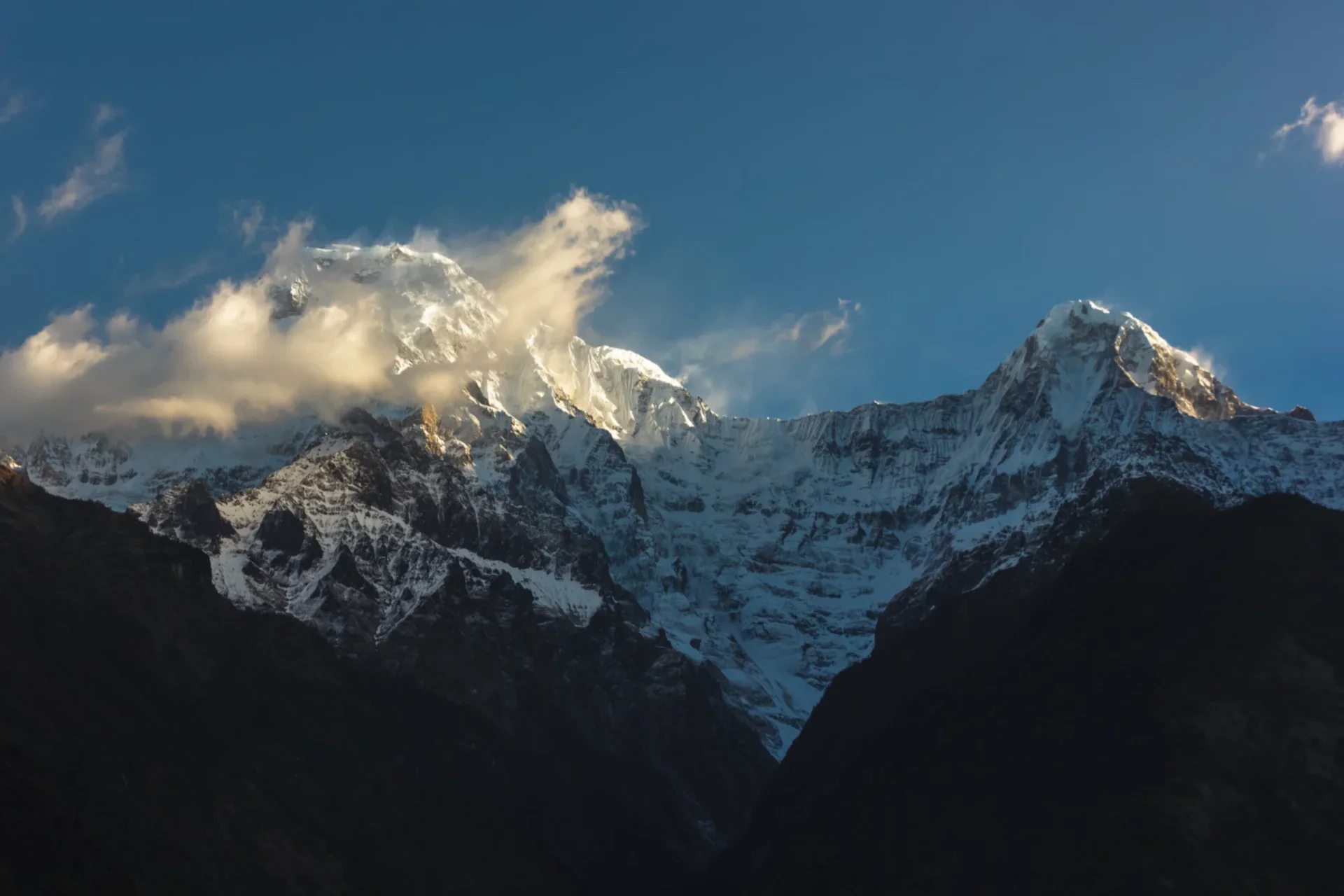 Snow-capped Himalayan mountain peaks in Nepal at golden hour — cheap country to visit in October for trekking