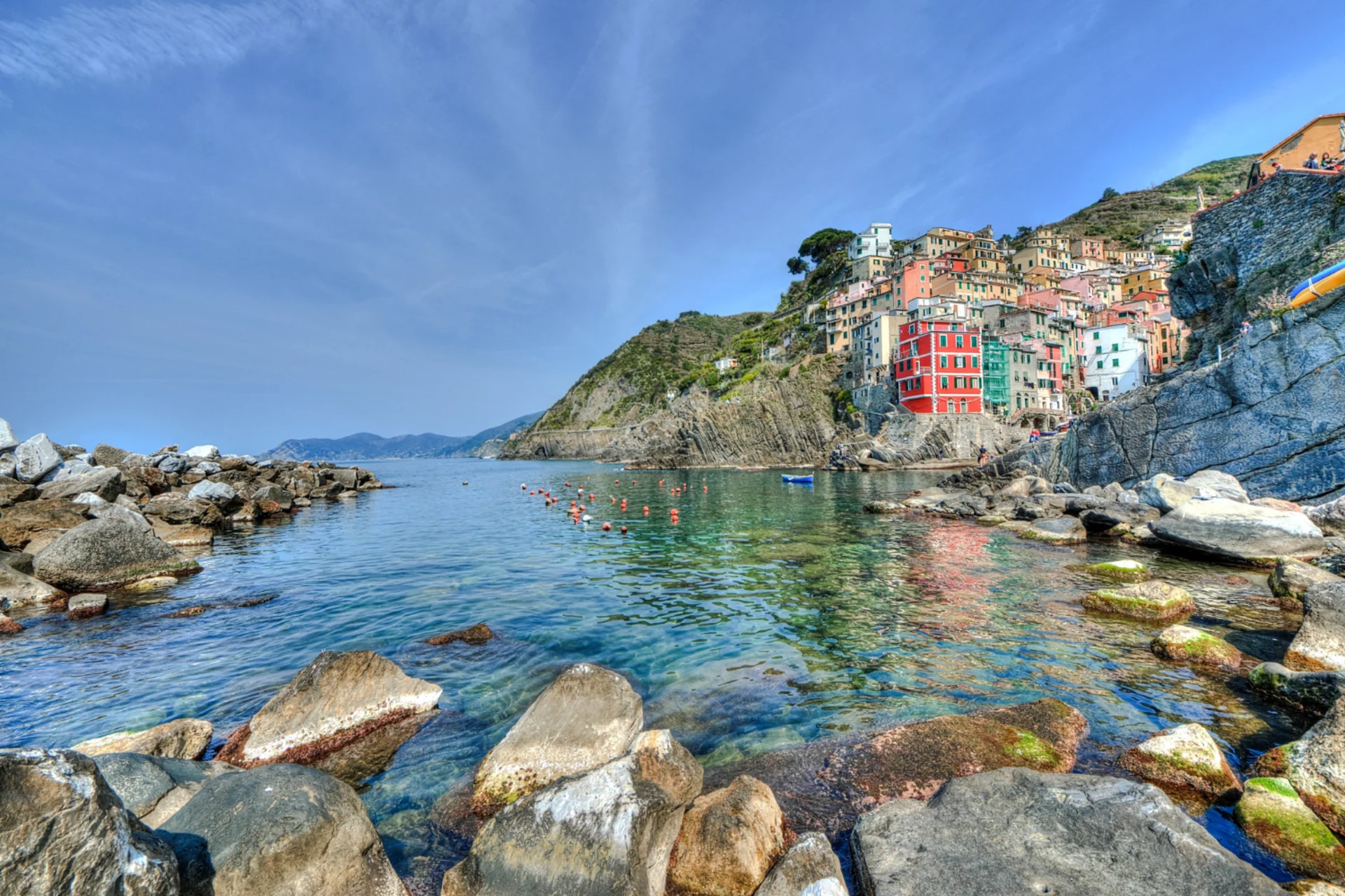 Scenic coastal view of Cinque Terre perched on cliffs in northwest Italy — a luxury romantic travel destination for November.