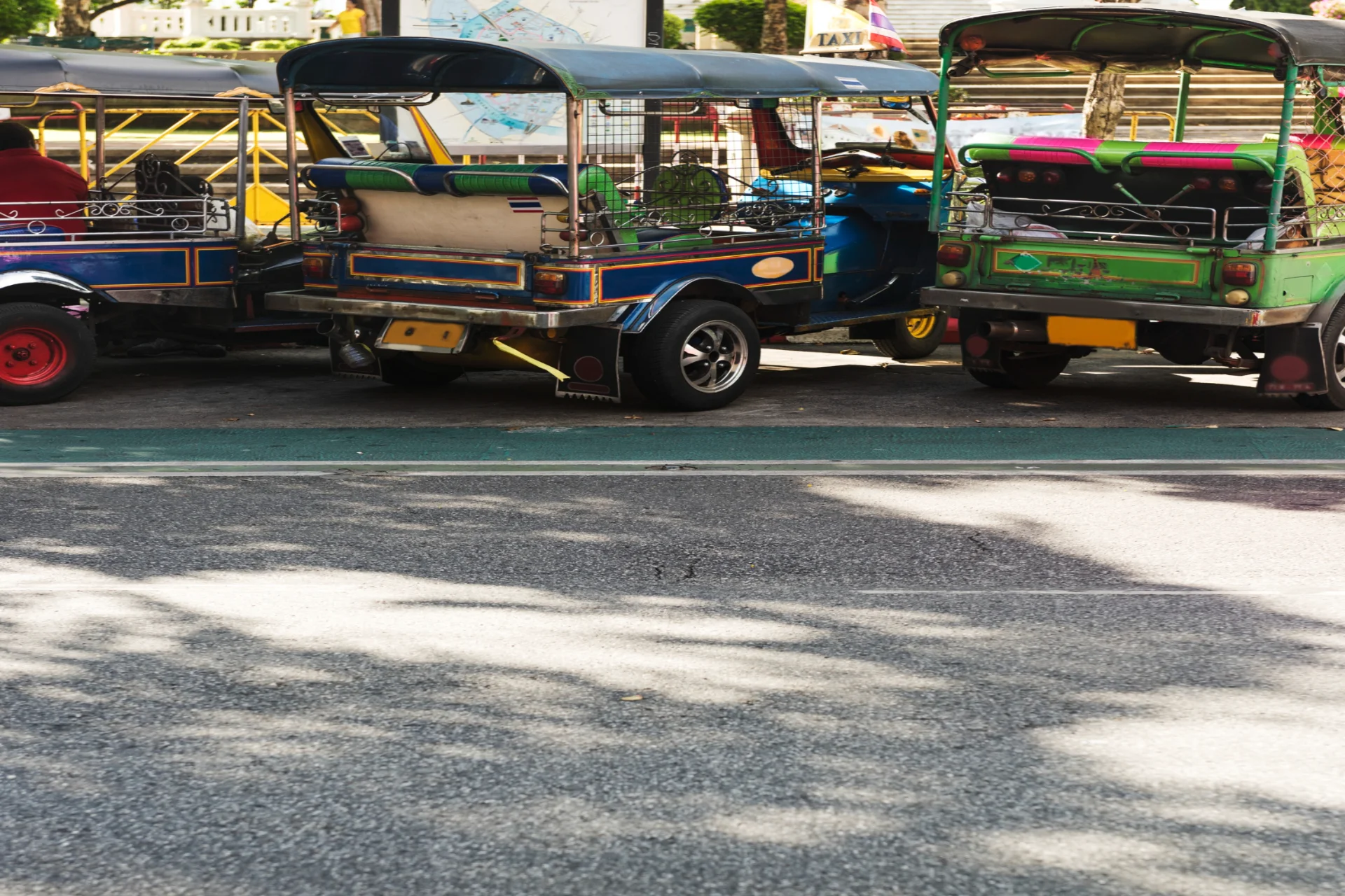 Tuk-tuks parked on a Bangkok street — Thailand transport convenience in Thailand vs UAE guide