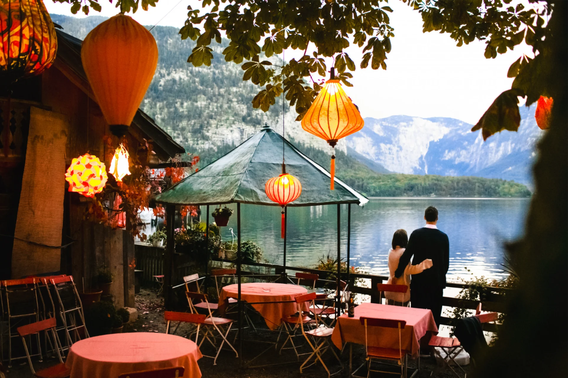 Couple standing at lakeside café decorated with Vietnamese lanterns — romantic Vietnam atmosphere in Vietnam vs Thailand couples travel guide