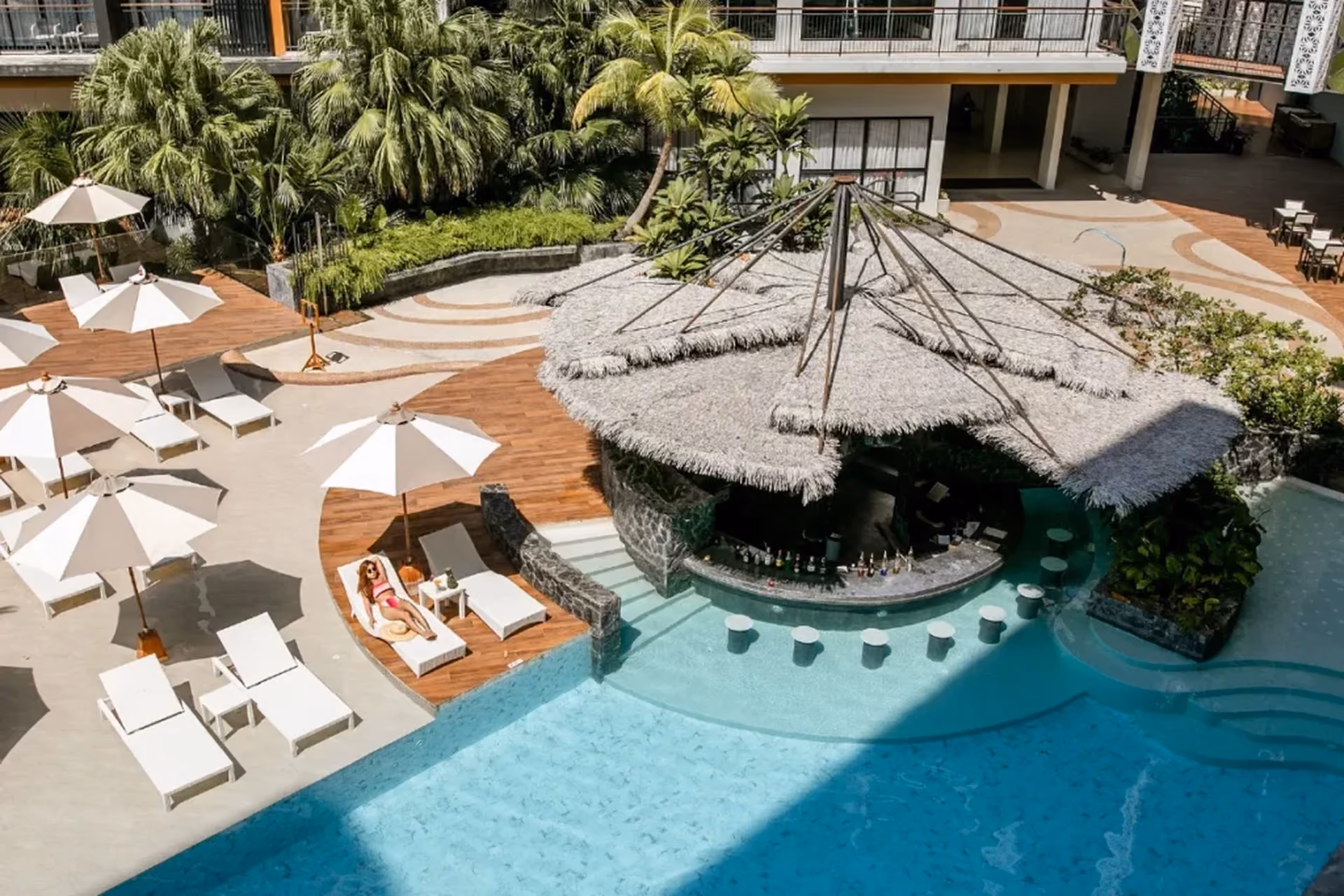 A swim-up pool bar, limestone cliff views from every balcony, and a tuk-tuk that drops you straight to the beach — Thailand's stay experience makes a quiet but convincing case in the Singapore vs Thailand debate for travellers who want their resort to feel like the holiday itself.