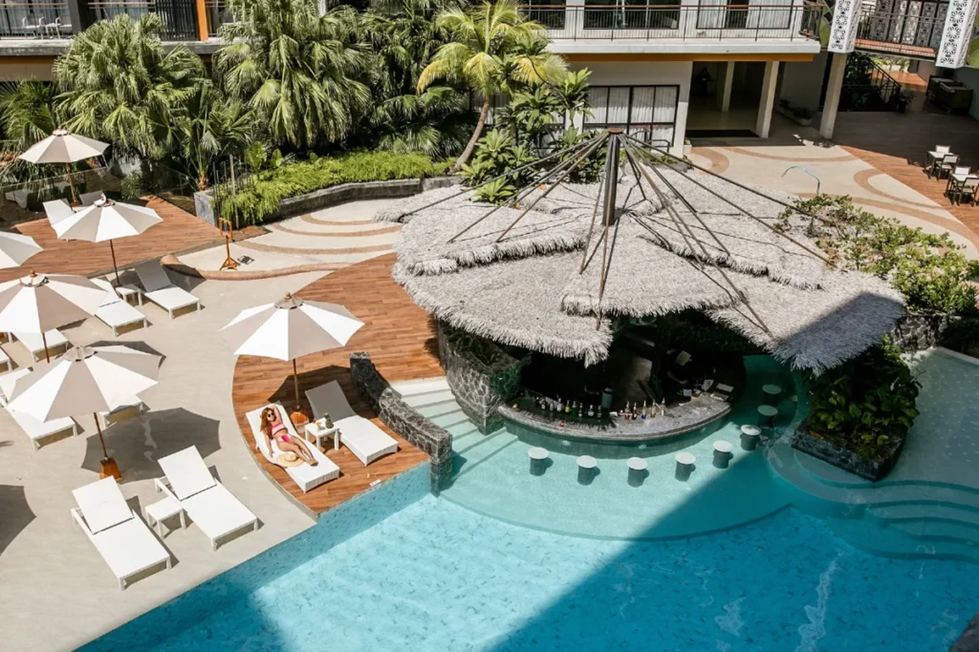 A swim-up pool bar, limestone cliff views from every balcony, and a tuk-tuk that drops you straight to the beach — Thailand's stay experience makes a quiet but convincing case in the Singapore vs Thailand debate for travellers who want their resort to feel like the holiday itself.