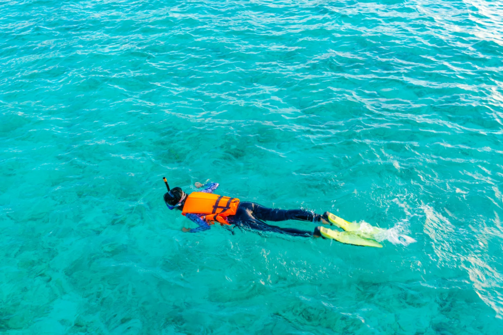 Snorkeler in turquoise ocean water — snorkeling cost comparison in Mauritius vs Maldives for Indian travelers on a budget