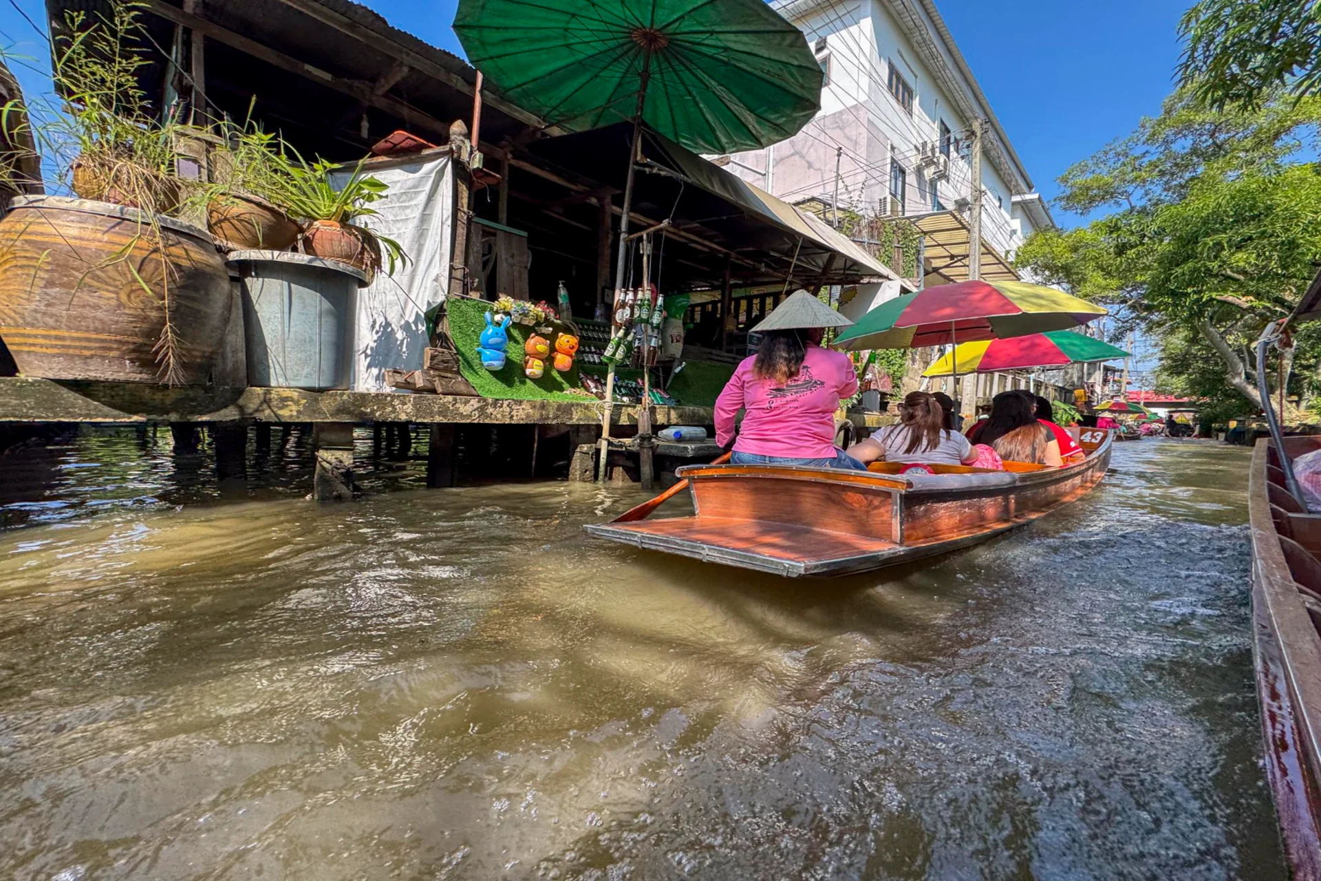 Vendors gliding through Thailand's famous floating markets by wooden boat — a grand cultural tradition that stands out in any Bali vs Thailand
