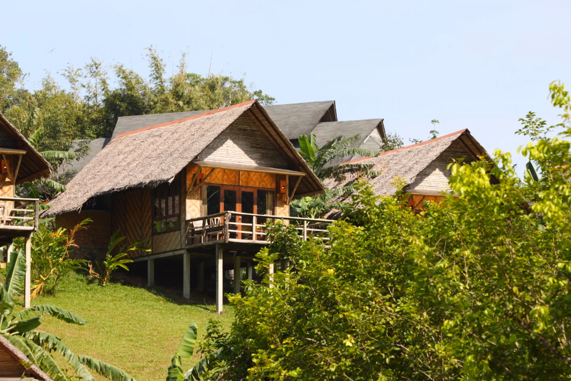Wooden hillside tea estate bungalows with thatched roofs surrounded by tropical greenery Sri Lanka – Cambodia vs Sri Lanka The Real Stay Experience Comparison