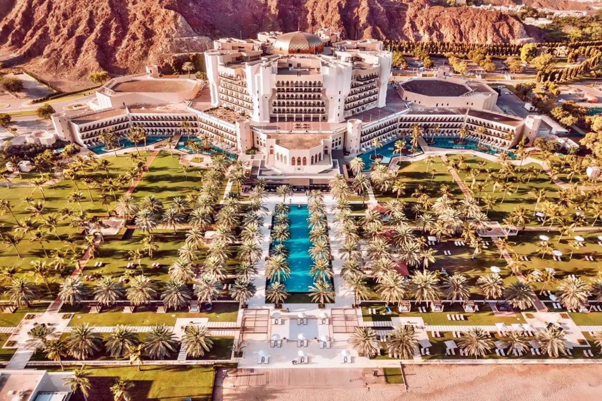 Al Bustan Palace, A Ritz-Carlton Hotel — a grand beachfront luxury property blending Omani heritage with private beach access and mountain views.