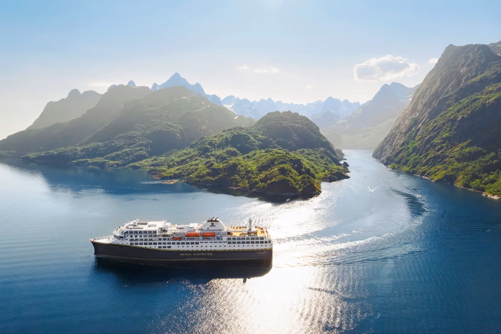 Top activities in New Zealand – scenic fjord cruise in Milford Sound with waterfalls and cliffs