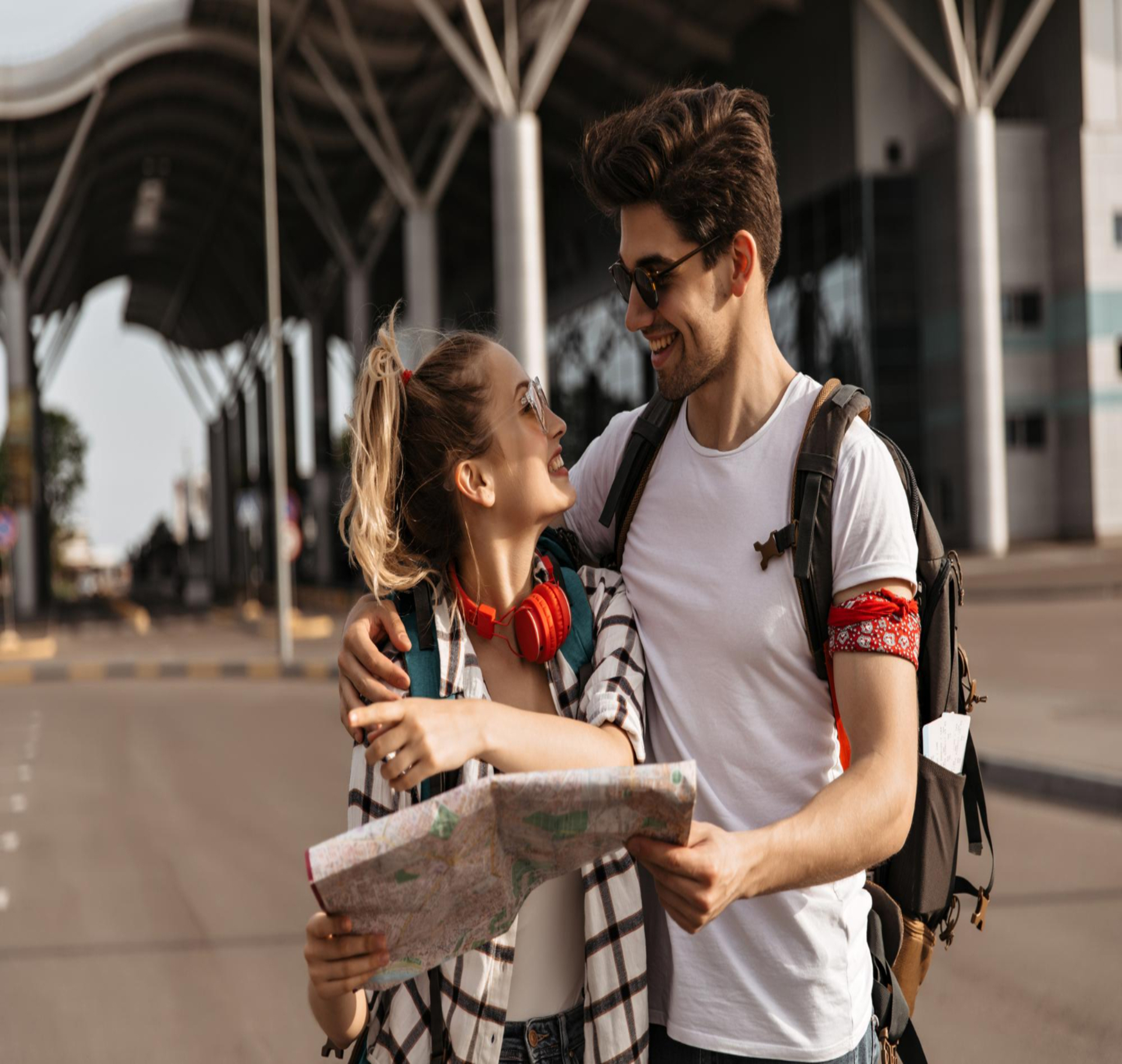 Here are alt text options under 125 characters: Option 1: "Couple with backpacks and map smiling outdoors — Georgia vs Azerbaijan travel stay picks by style