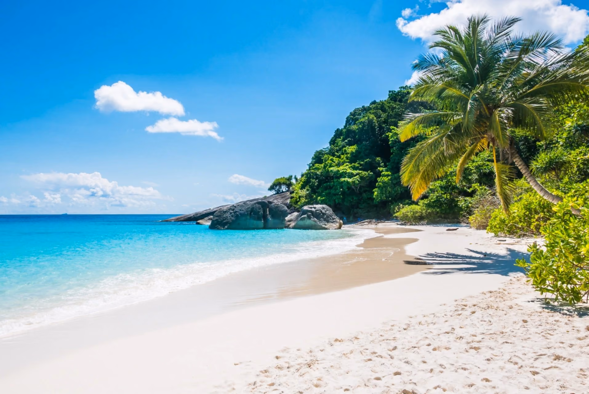 Mauritius vs Maldives beaches in July featuring white sand shoreline, turquoise waters, palm trees, and peaceful tropical island scenery
