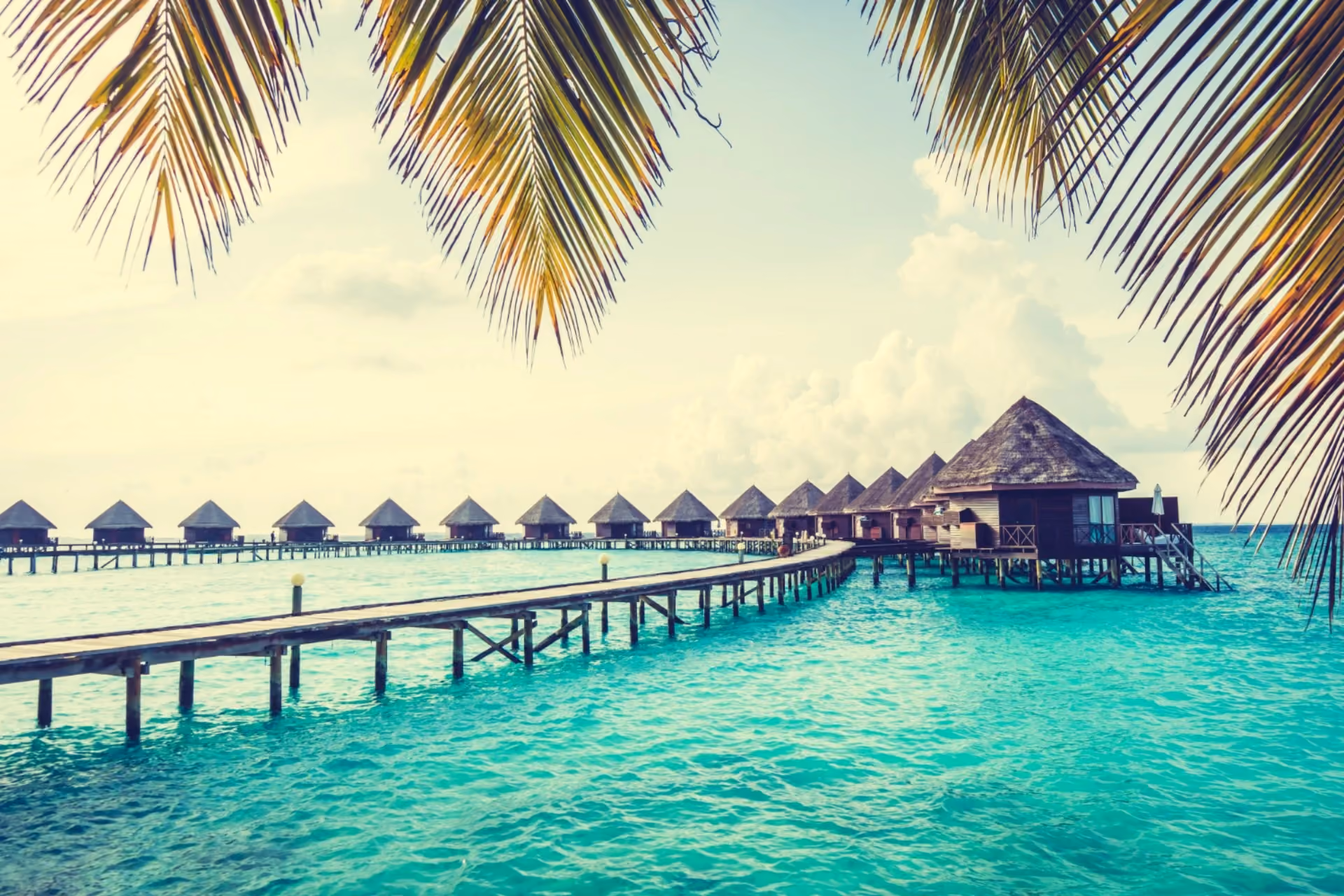 Mauritius vs Maldives comparison showing luxury Maldives overwater villas, turquoise lagoon views, and peaceful tropical resort escape