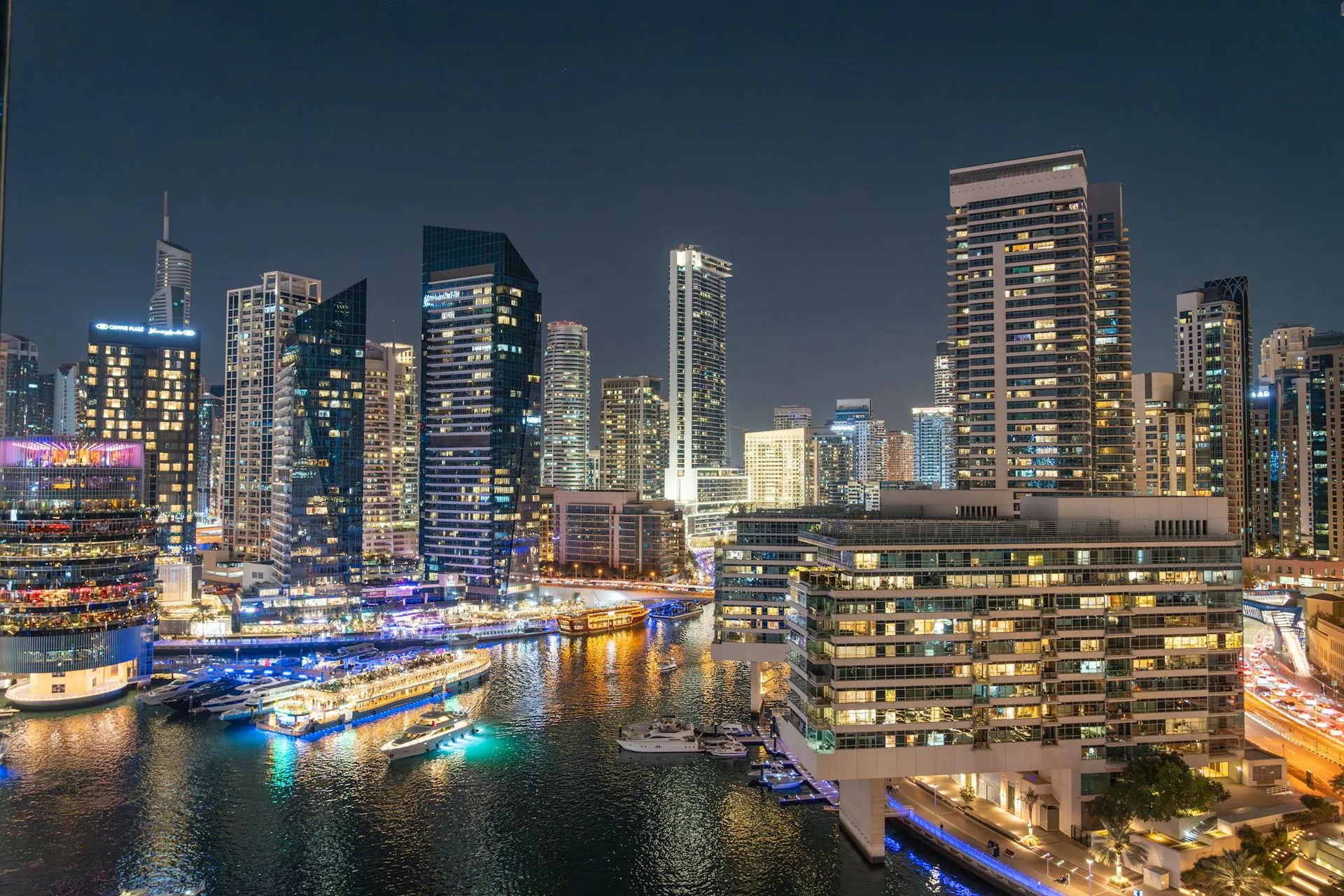 Dubai Marina skyline illuminated at night, reflected on the water