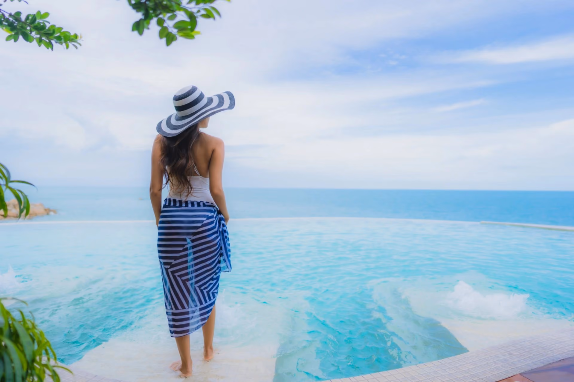 Traveller enjoying a tropical beach in Thailand, ideal for those comparing Vietnam vs Thailand for their next vacation