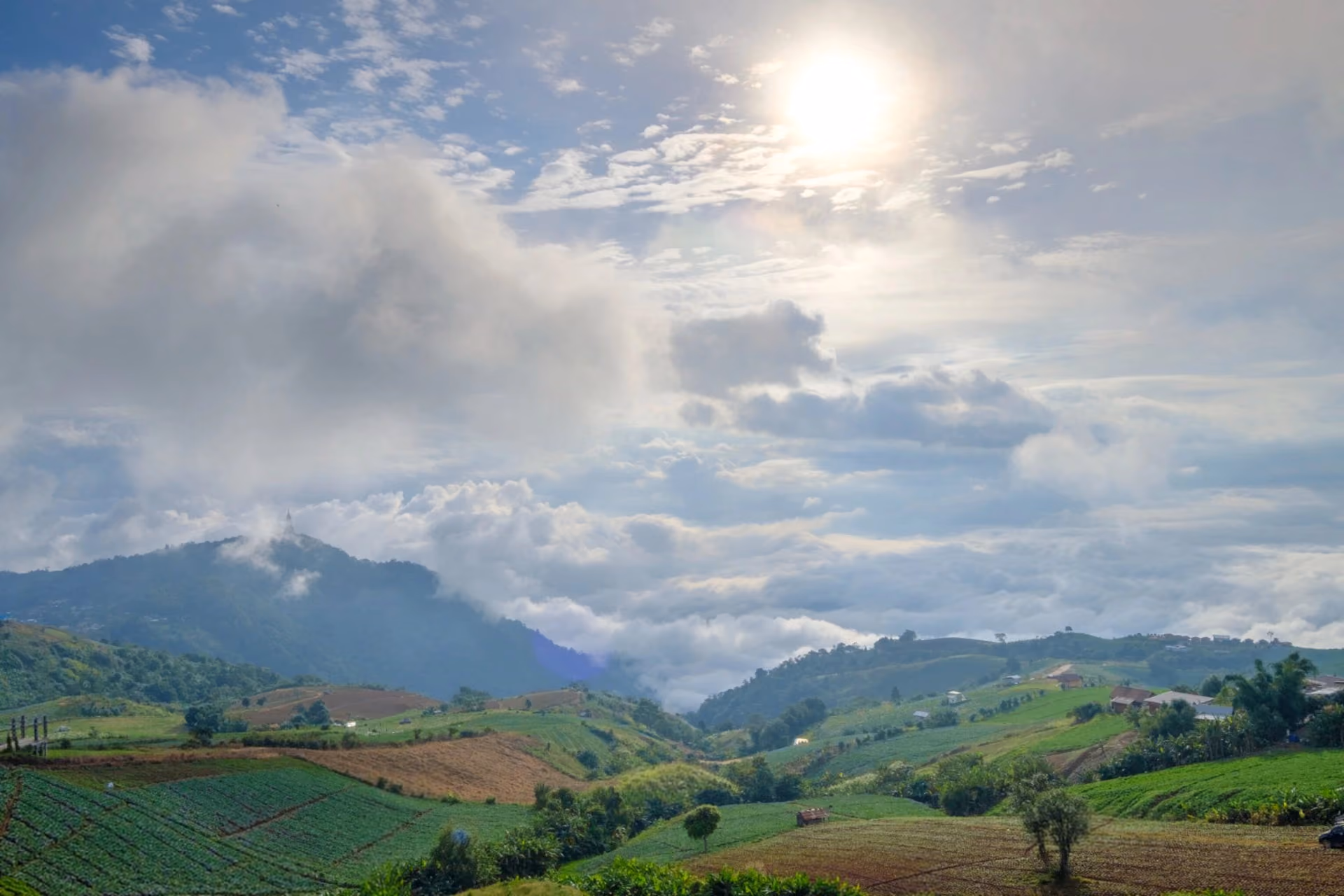 Lush green hills and cloudy sunny sky in Vietnam — weather in June Bali vs Vietnam