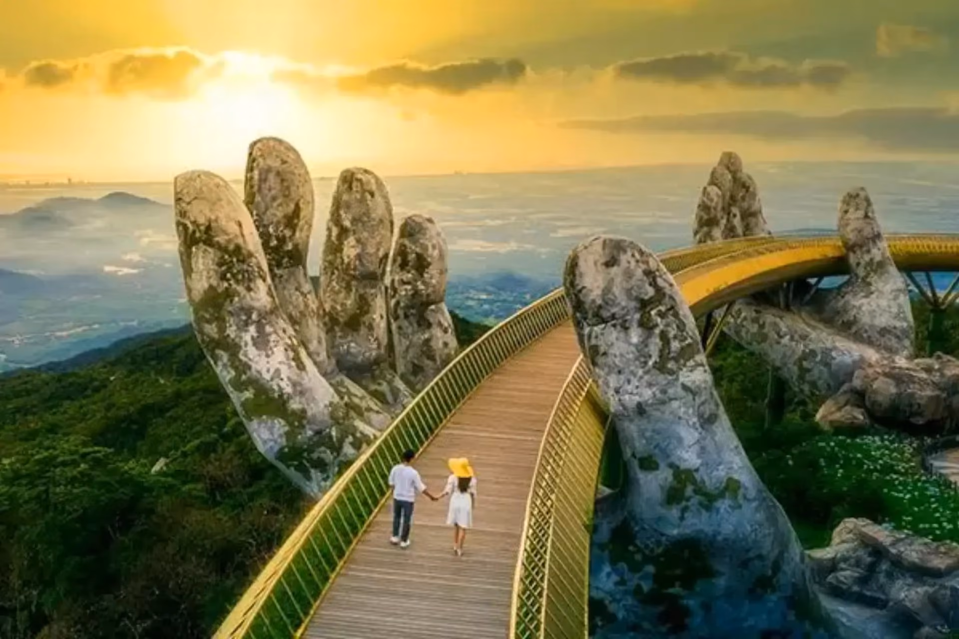 Couple walking on Golden Bridge held by stone hands