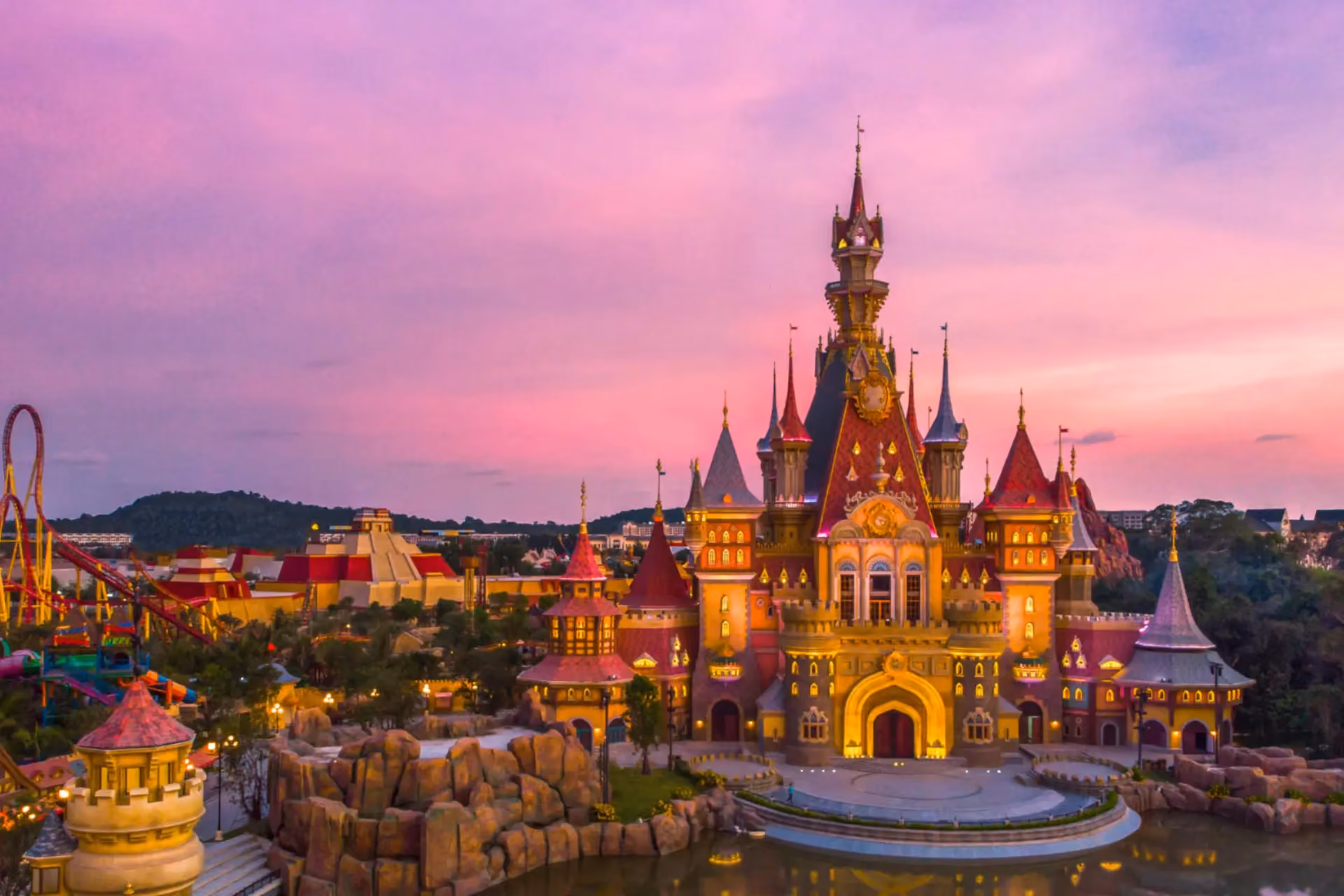 Vinwonders Phu Quoc castle lit up at sunset with pink sky