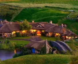 Hobbiton Movie Set homes built into green hillside at night