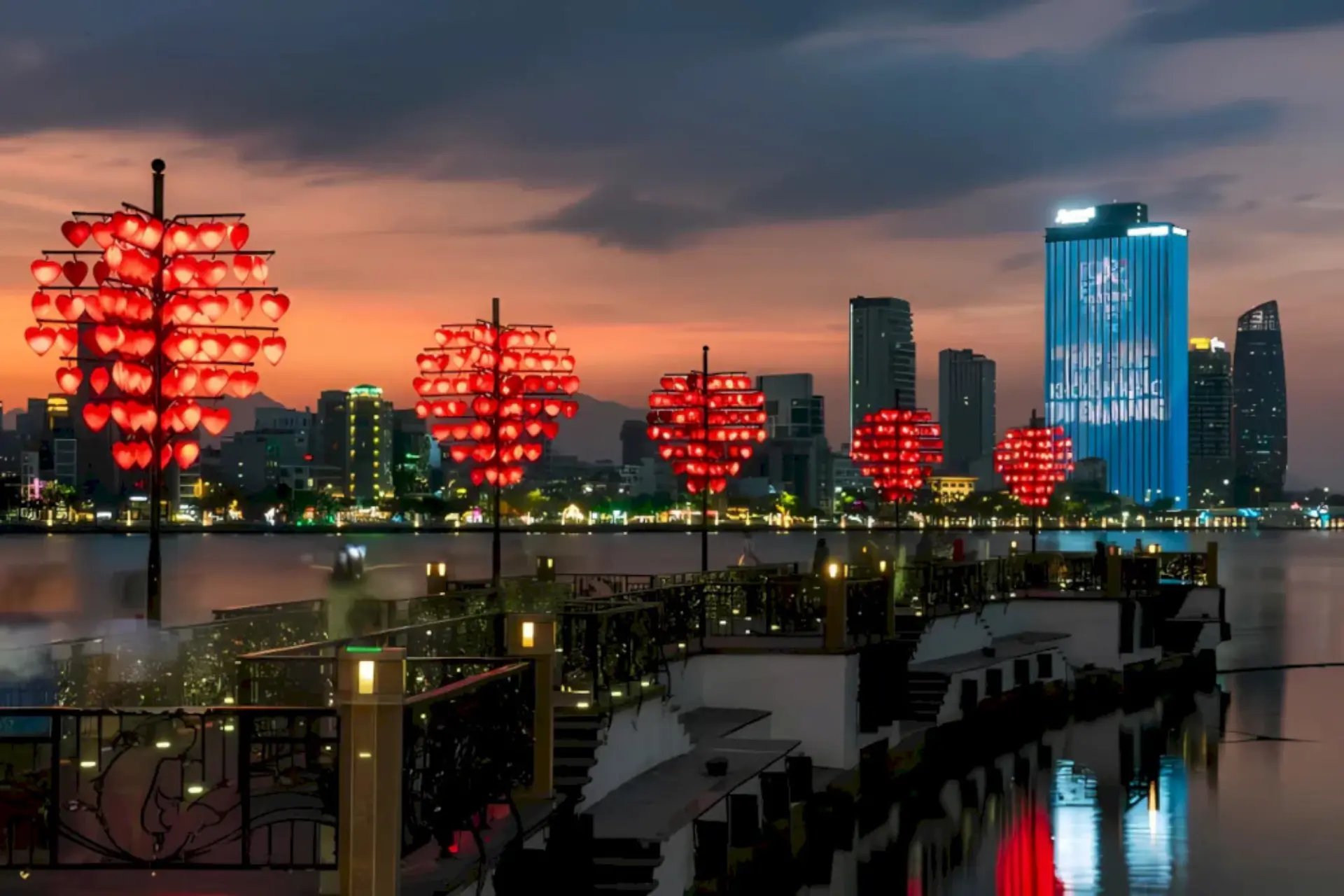 Red heart lights on bridge over water Da Nang
