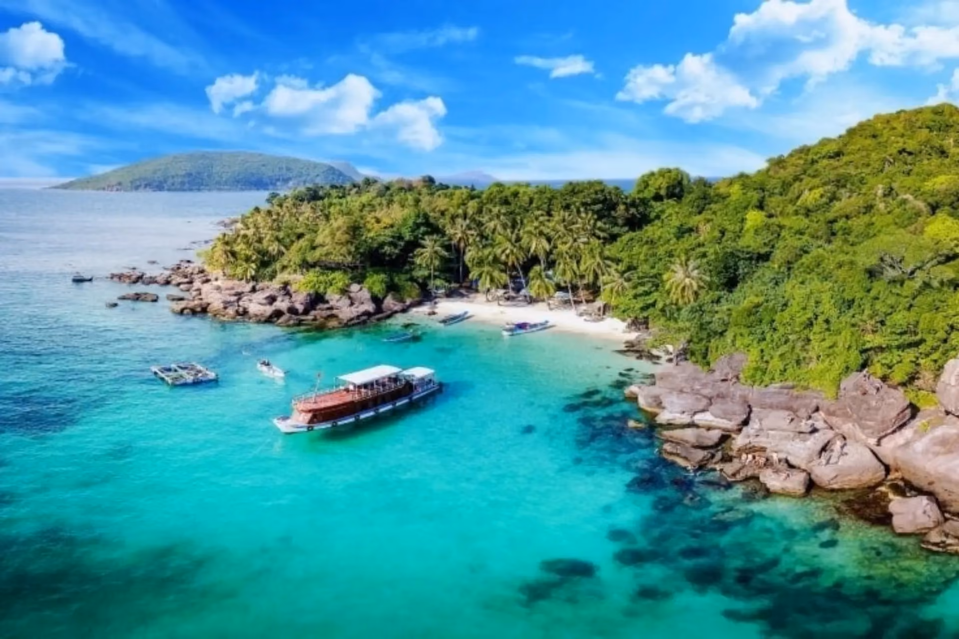 Boats on clear blue water near Phu Quoc Island beach