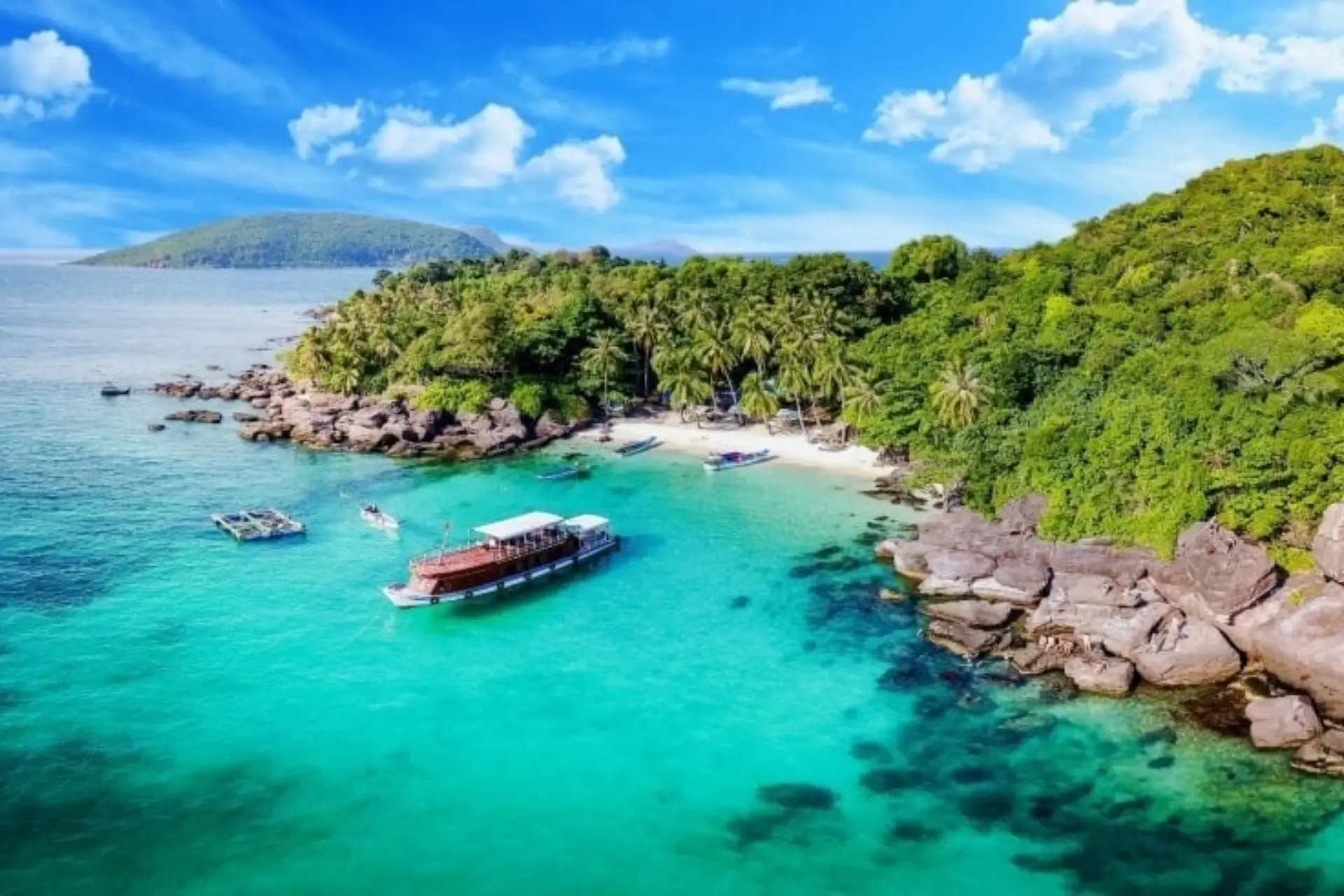 Boats on clear blue water near Phu Quoc Island beach