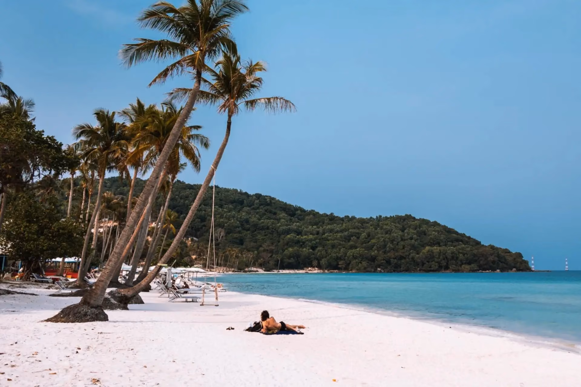 Phu Quoc beach with palm trees and clear blue water