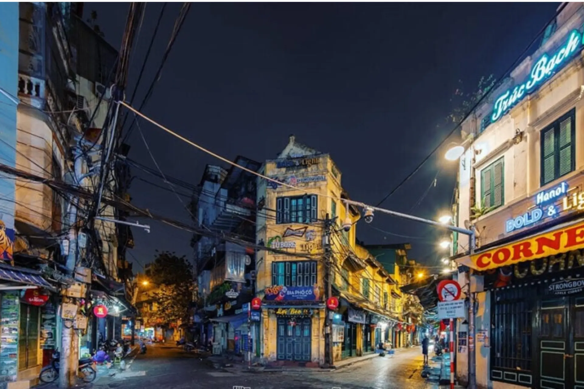 Hanoi Old Quarter street at night with yellow buildings