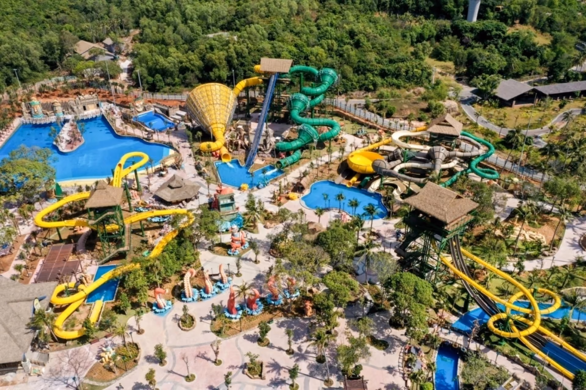 Aquatopia water park with yellow and green slides and pools